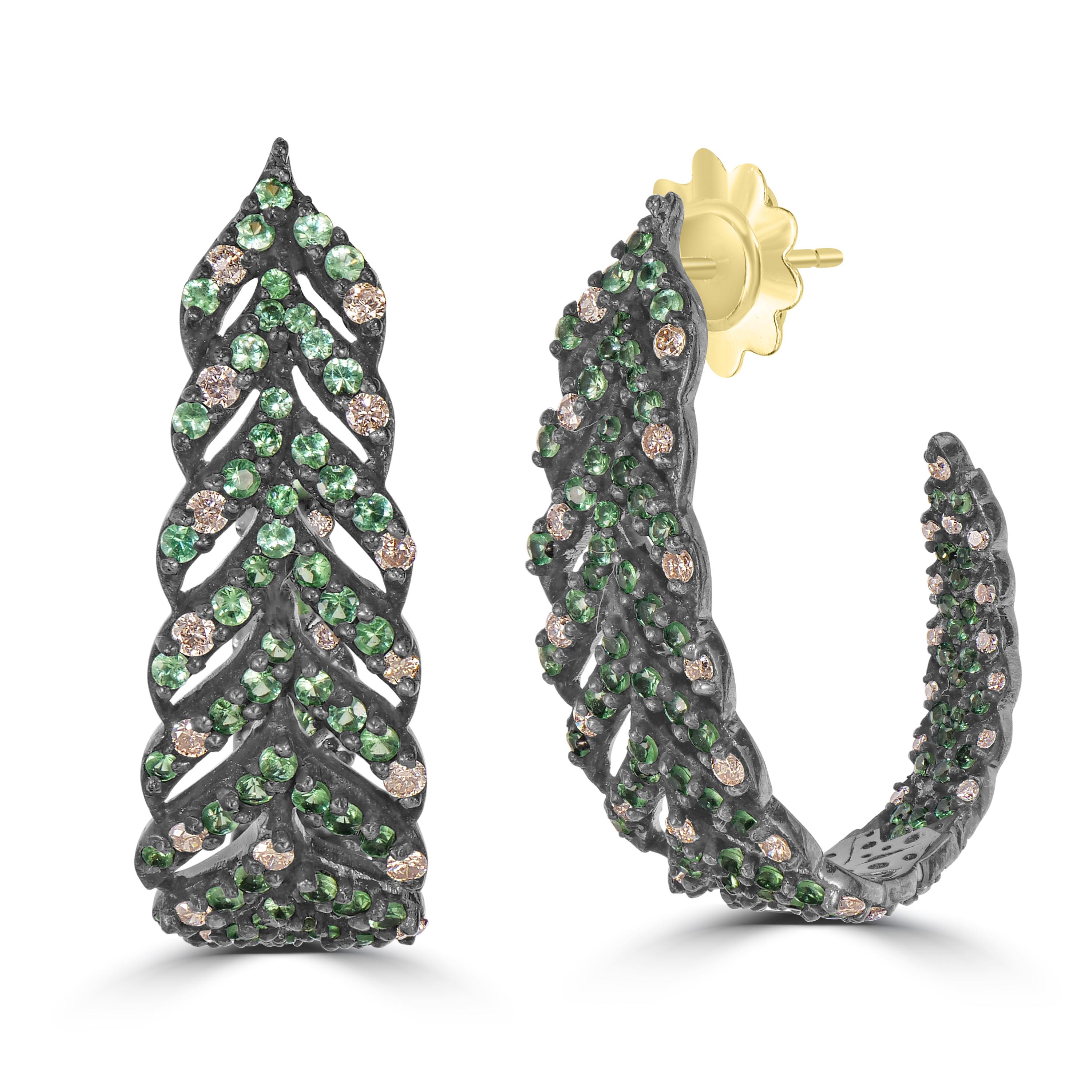Introducing our Victorian 3.03 Cttw. Tsavorite and Diamond Leaf Hoop Earrings, a testament to the timeless beauty of nature and expert craftsmanship.

Crafted with precision, these hoop earrings feature a delicate arch made of black rhodium on