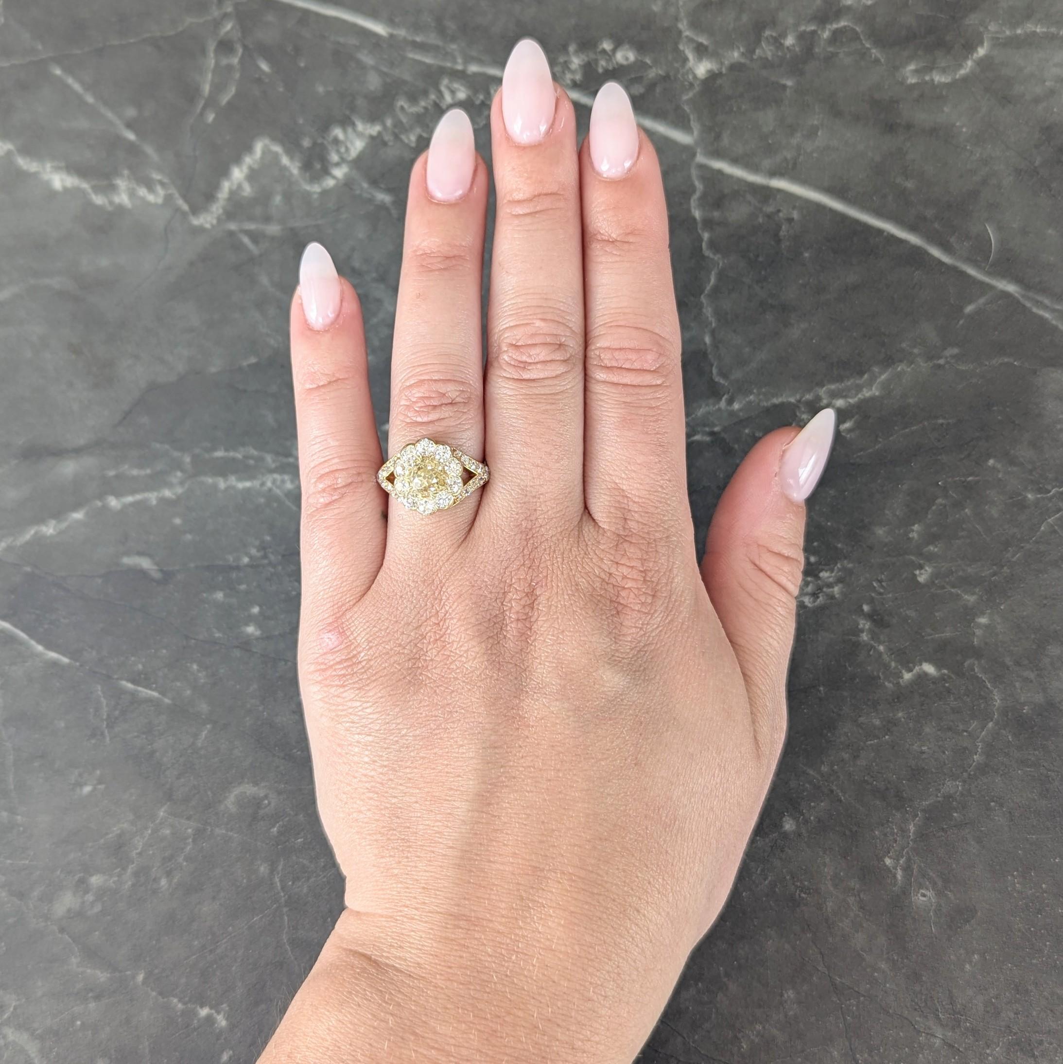 Centering a old mine cut diamond weighing approximately 1.42 carats
Fancy intense orangy-yellow color with SI1 clarity - set with talon prongs
Featuring a halo surround of old European cut diamonds
Weighing approximately 1.20 carats total - G/H