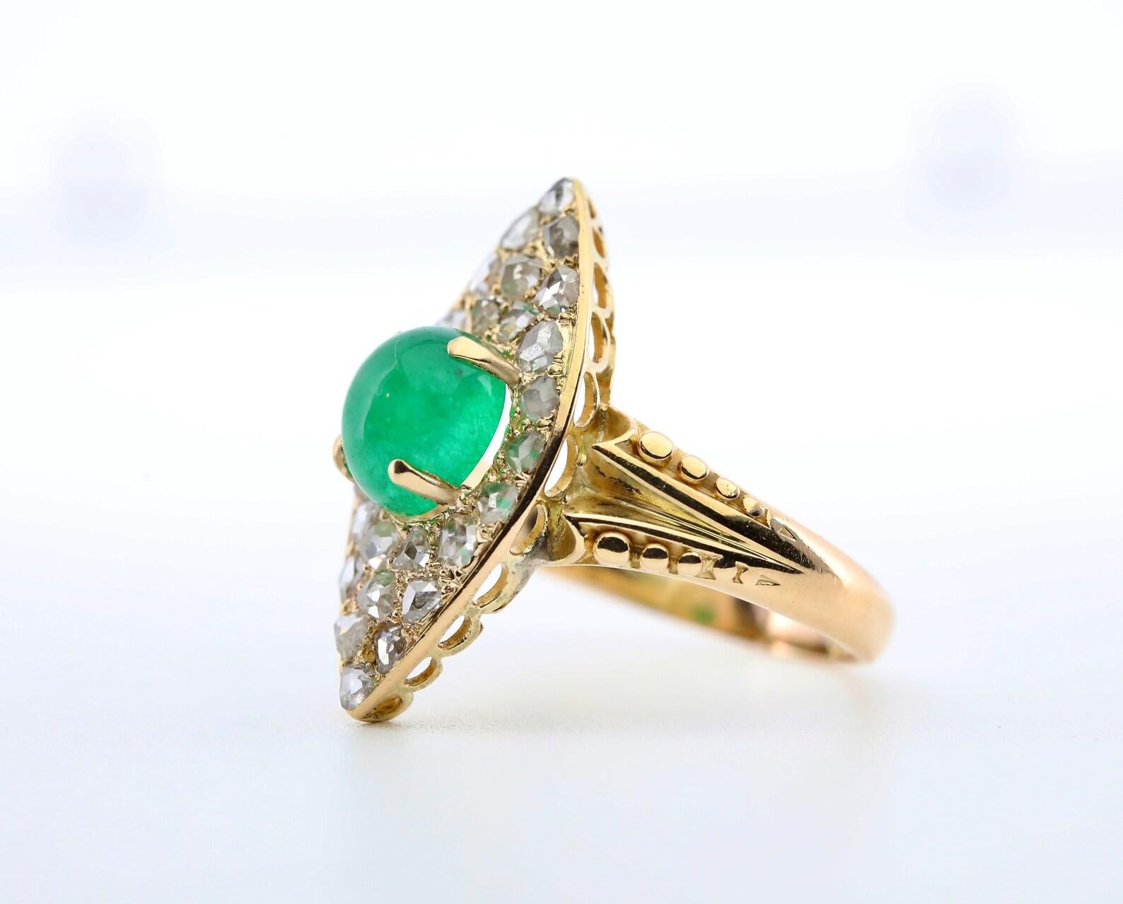 An original victorian period emerald and diamond ring in 18 karat yellow gold.

Centered by a 2.06 carat cabochon cut emerald of beautiful rich green color.

The mounting set with 26 antique rose cut diamonds of 1.02ctw with F to H color, and VS to