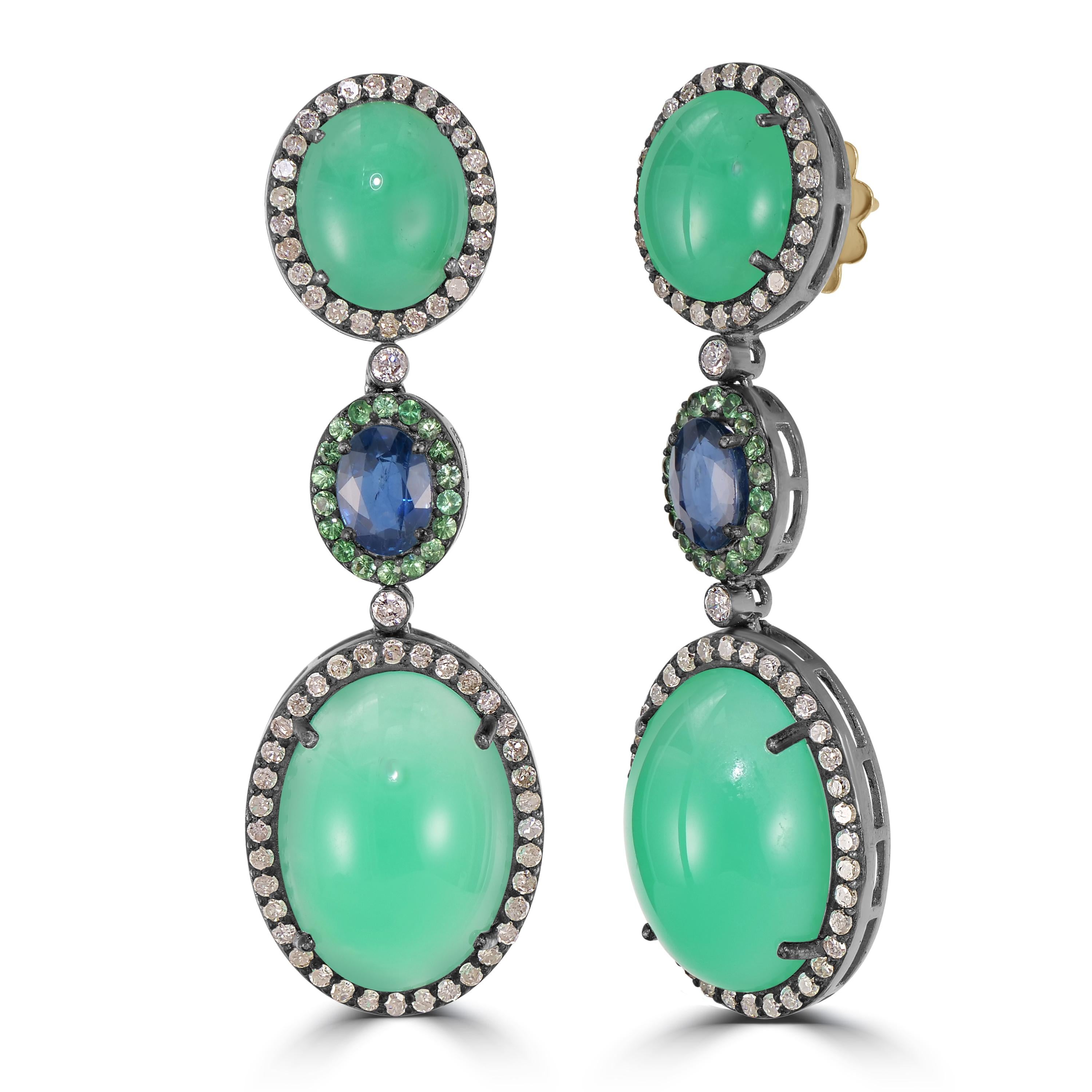 Indulge in the timeless opulence of the Victorian 31.35 Cttw. Chrysoprase, Blue Sapphire, Tsavorite, and Diamond Earrings, a mesmerizing symphony of vivid gemstones and diamonds that cascade in three enchanting drops. Crafted with precision, these