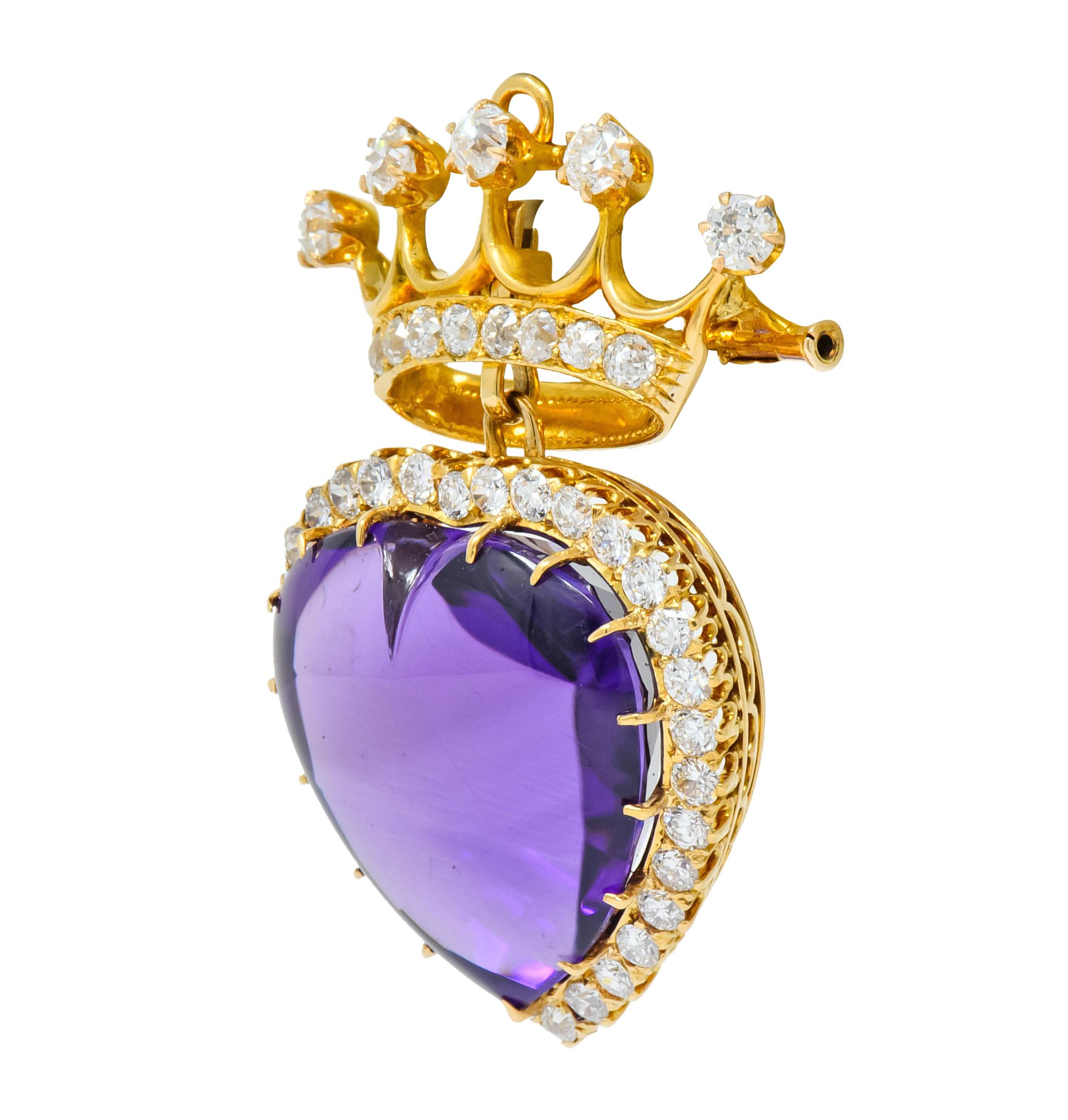 Brooch designed as polished gold crown with articulated heart drop featuring a heart cabochon amethyst measuring approximately 22.0 x 22.0 mm, medium-dark purple in color

Crown is accented by and heart is surrounded by old European cut diamonds
