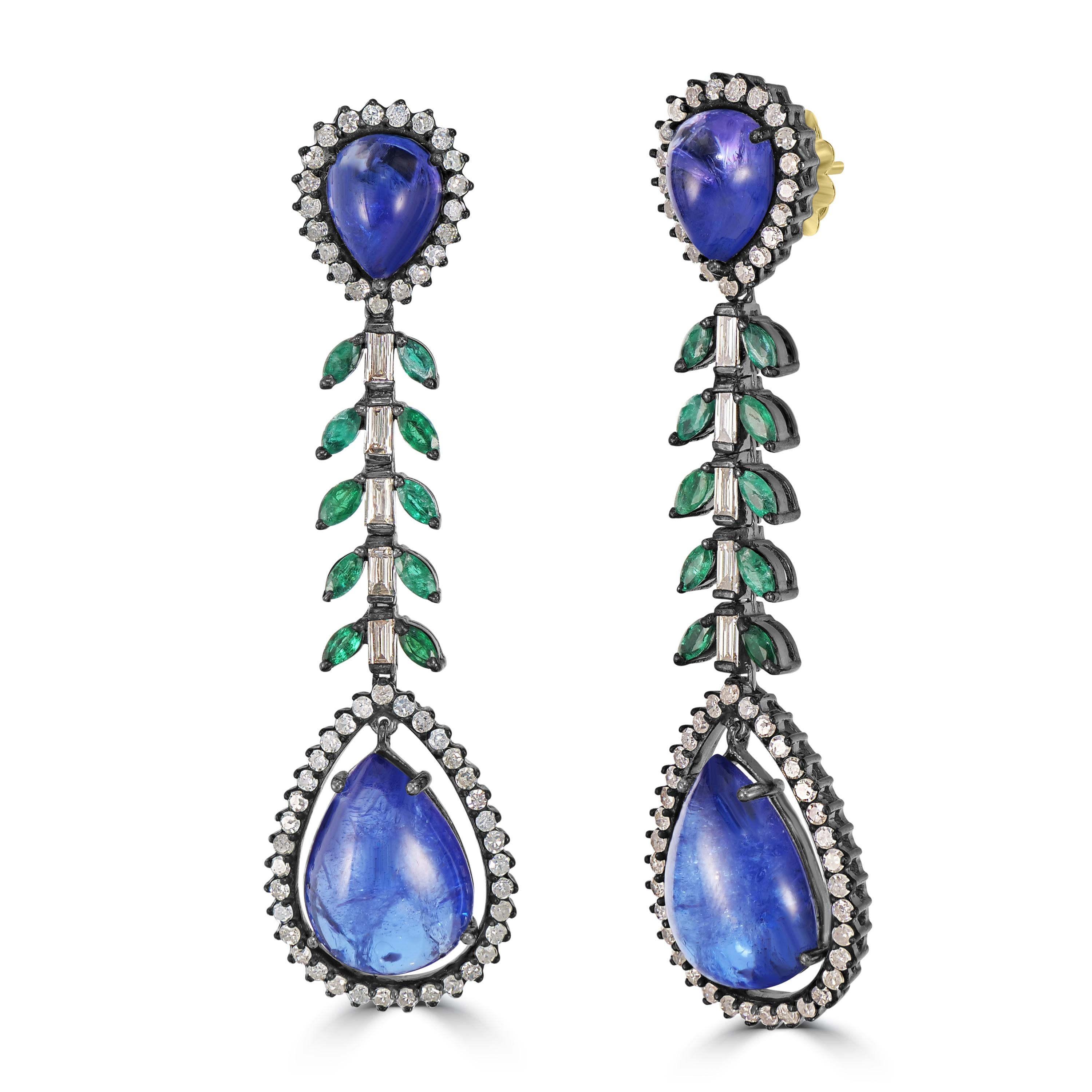 Introducing our Victorian 33.22 Cttw. Tanzanite, Diamond, and Emerald Dangle Earrings—an exquisite manifestation of timeless beauty and natural grace.

At the heart of these earrings are the pear-shaped tanzanites, delicately positioned at both the