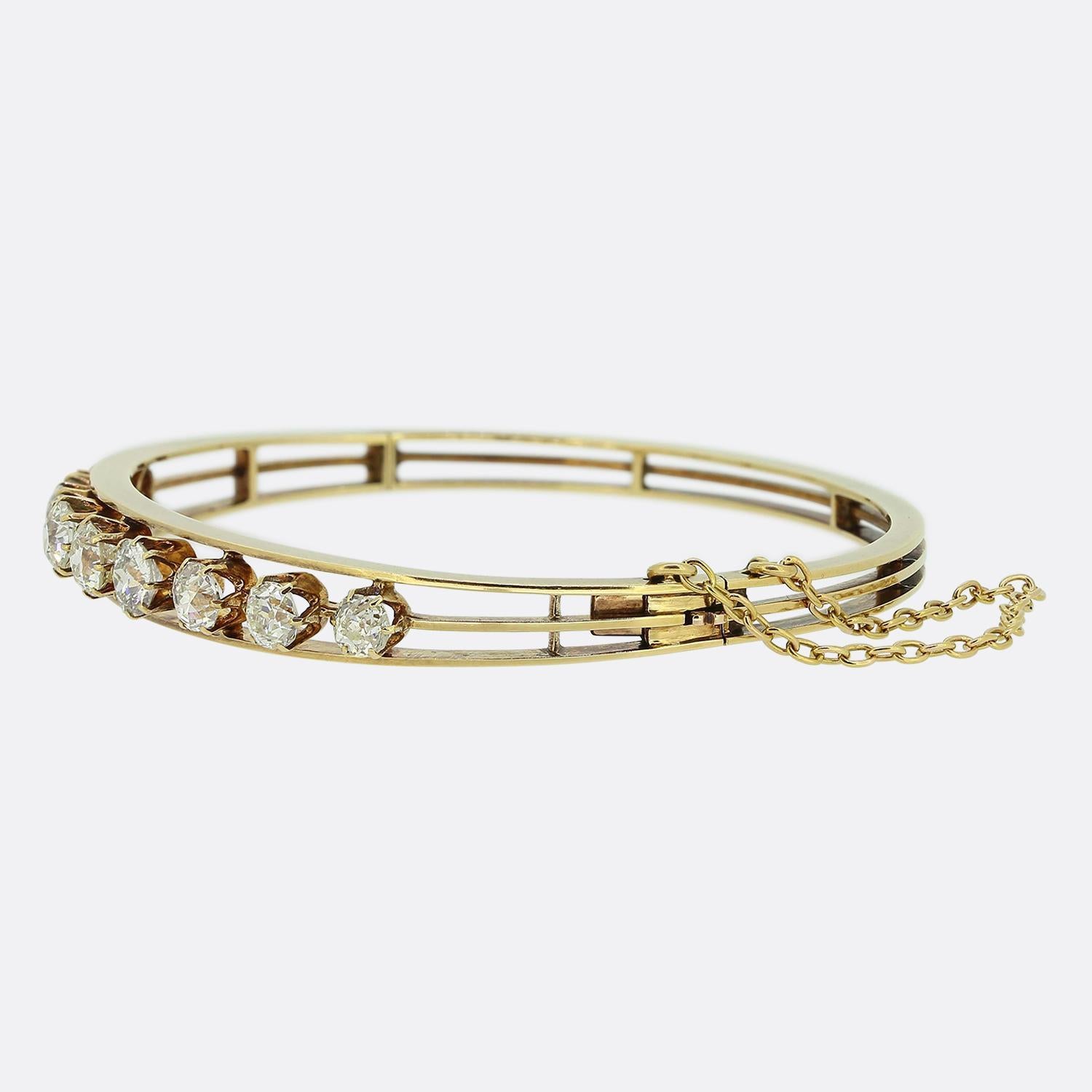 Here we have a marvellous diamond bracelet dating back to the Victorian era. This antique piece has been crafted from a warm 15ct yellow gold with a slight pinky tint and showcases an open design consisting of three horizontal bars which wrap neatly