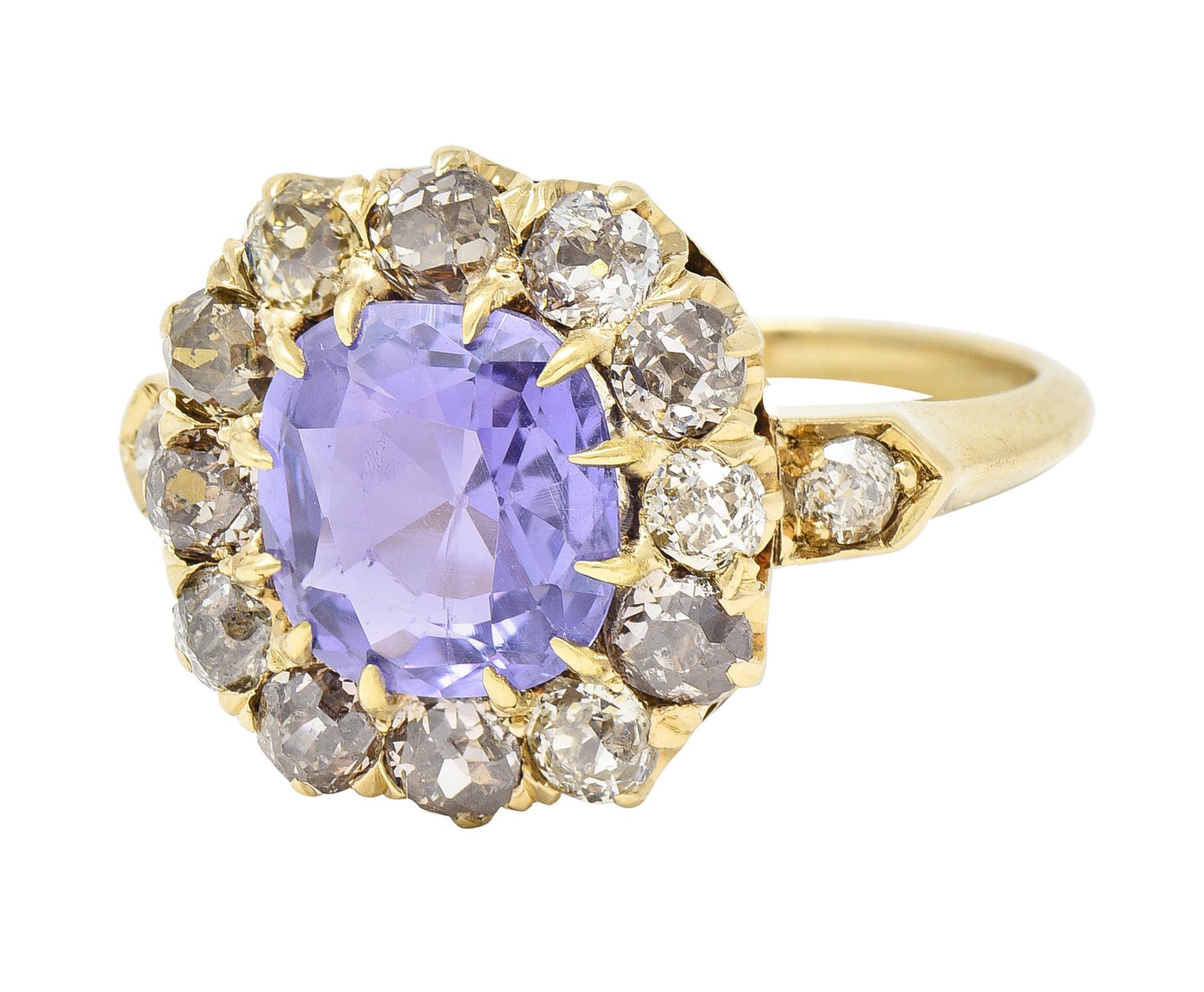 Centering a cushion cut sapphire weighing 2.24 carats - transparent light purple in color
Natural Ceylon in origin with no indications of heat treatment 
Prong set with a halo surround of old mine cut diamonds
With additional diamonds bead set in
