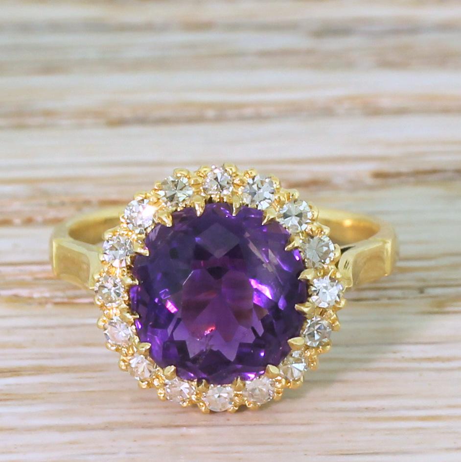 A Victorian amethyst ring of absolute quality. The extraordinary deep, rich and bright purple old cut amethyst in the centre is claw set within a surround of sixteen top white eight-cut diamonds. The gems are secured within a classic Victorian