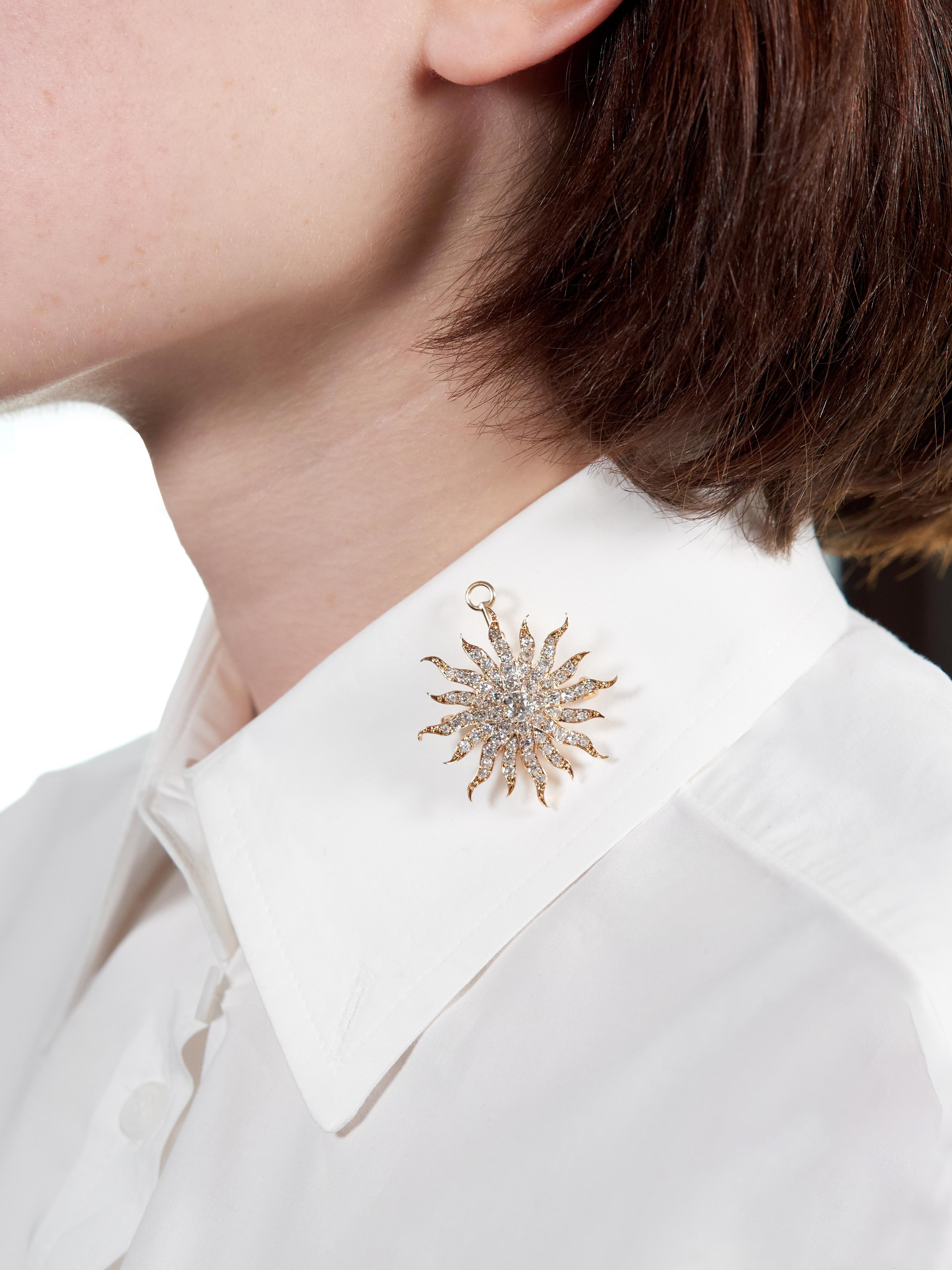 Designed as a yellow gold radial starburst form with fanning tendril-like rays
Centering an old mine cut diamond weighing approximately 0.60 carat
L color with VS2 clarity - prong set with additional diamonds on rays
Bead set and weighing