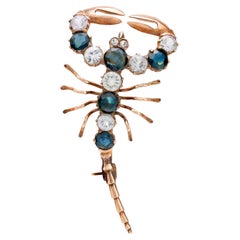 Victorian 4 carat blue and white sapphire 10k rose gold scorpion brooch