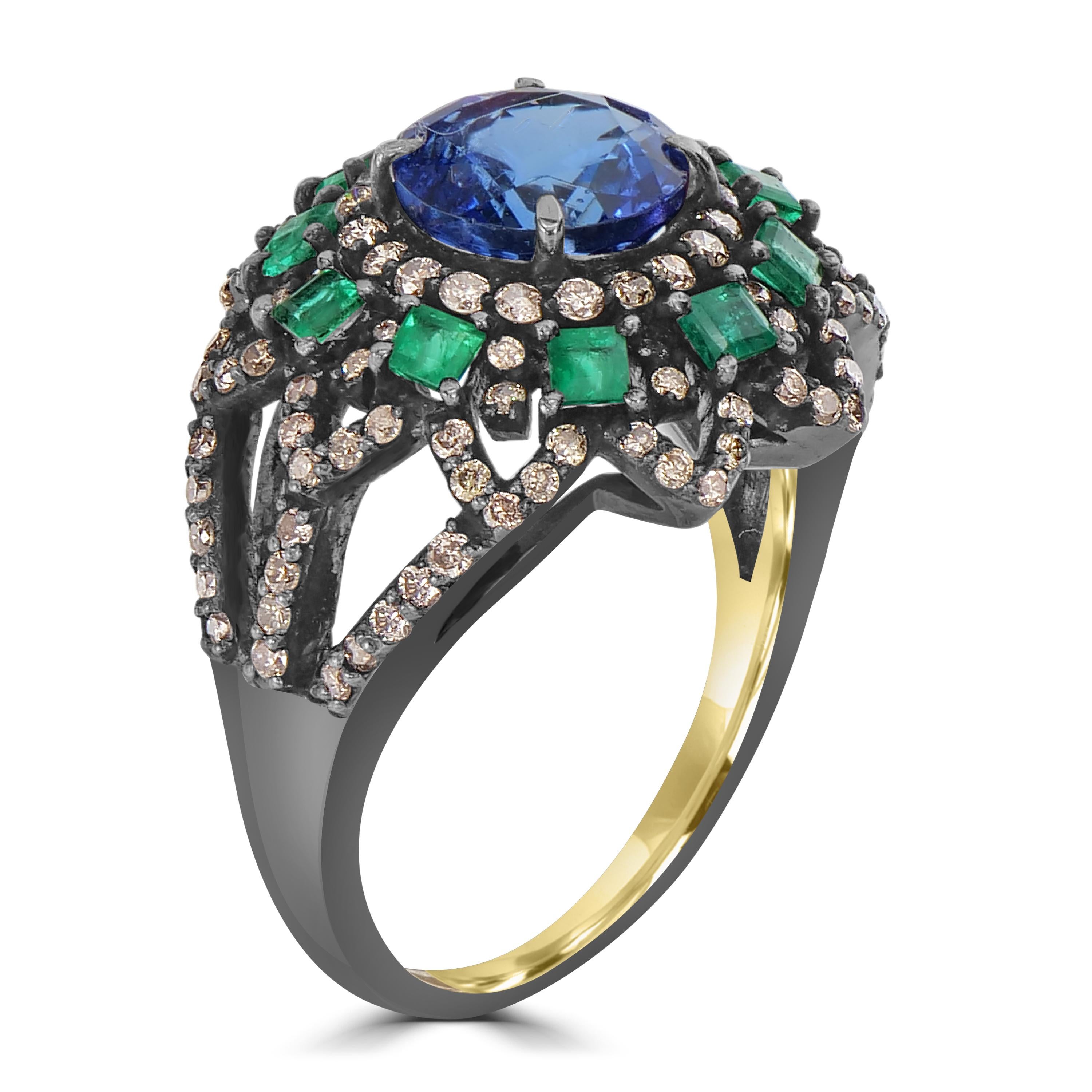 Step into the grandeur of the Victorian era with the 4 Cttw. Tanzanite, Emerald, and Diamond Split Shank Cocktail Ring — a mesmerizing embodiment of classic elegance and contemporary design. At its heart, an oval tanzanite takes center stage,