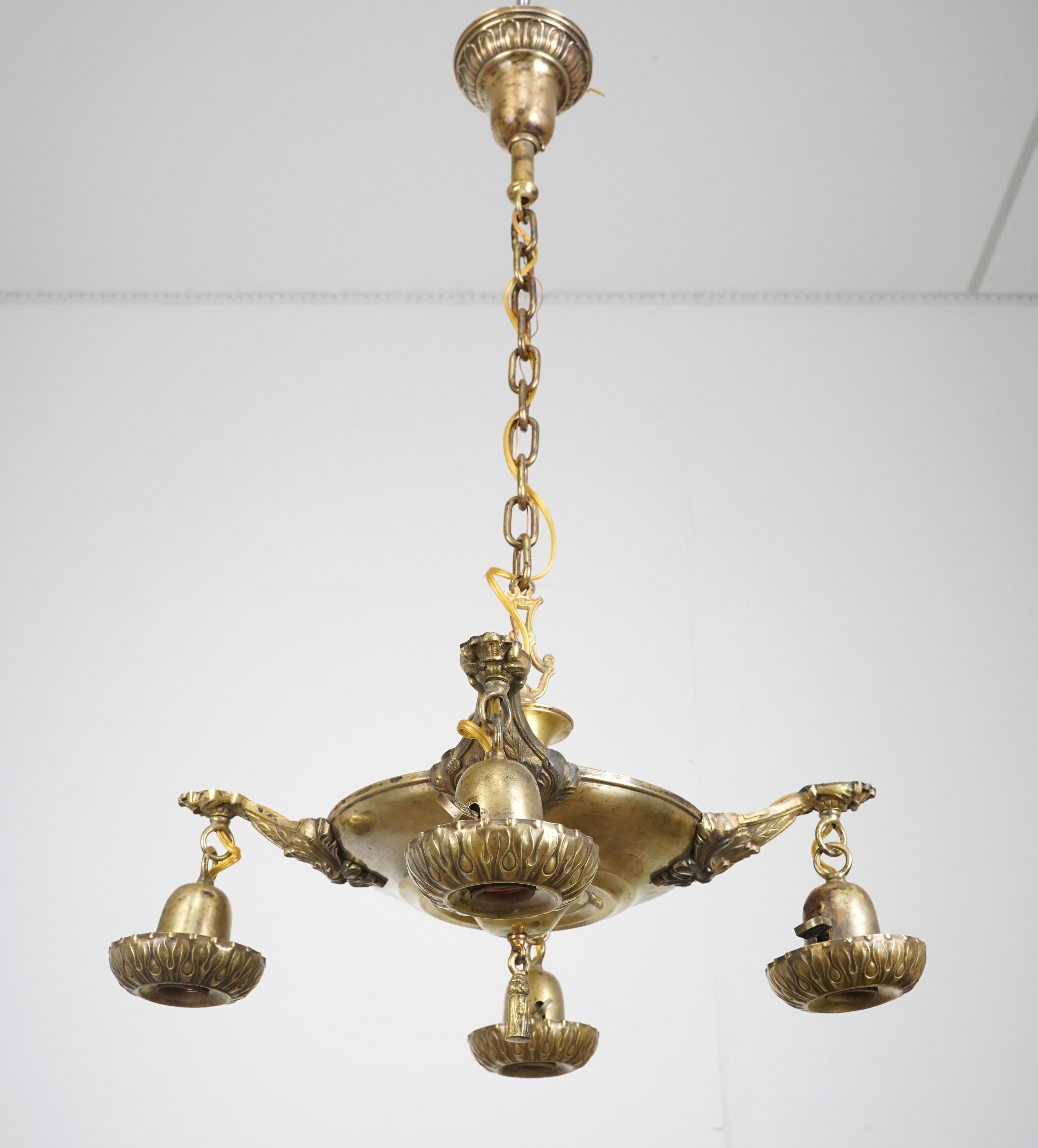 Victorian style chandelier made of brass with four exposed drop light bulbs. The chain is made of steel. This requires four standard Edison style medium base bulbs. This light is cleaned and restored and ready to ship. One available. Please note,