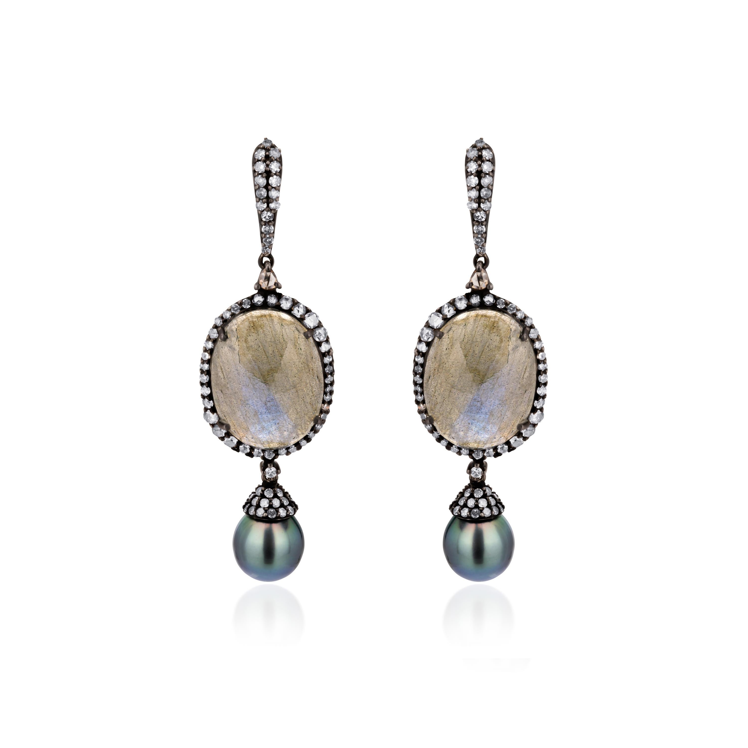 Soft and elegant, feminine beauty radiates from these fabulous Victorian ear drops. Masterfully created in 18K gold and 925 sterling silver each earring showcase an oval labradorite framed within diamonds culminating in tender pearl drops. A