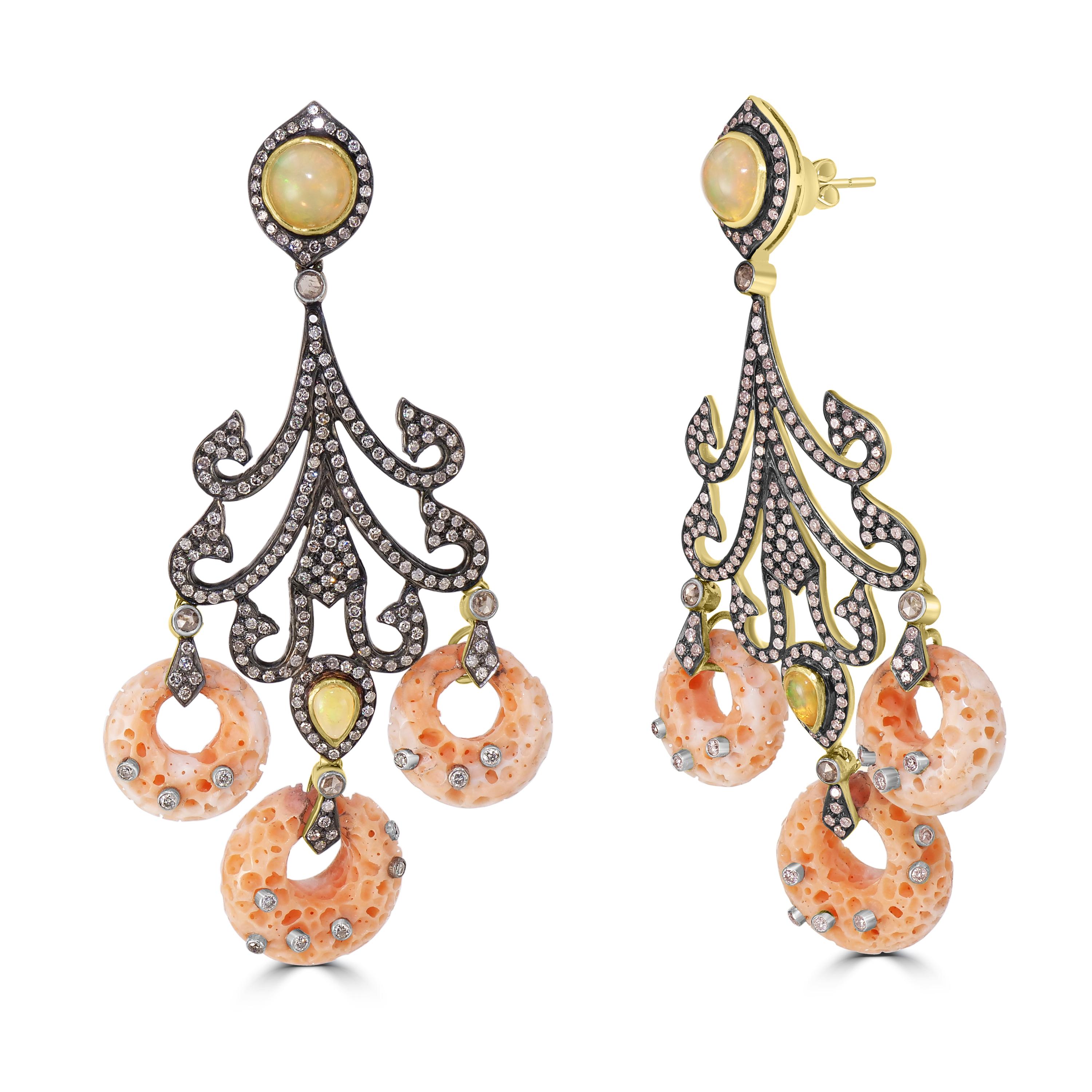 These exquisite Victorian-inspired dangle earrings are a stunning statement piece. Crafted with 41.64 carats of coral, opal, and diamonds, these earrings feature a unique design with oval opals in diamond halos, and diamond arms holding donut-like