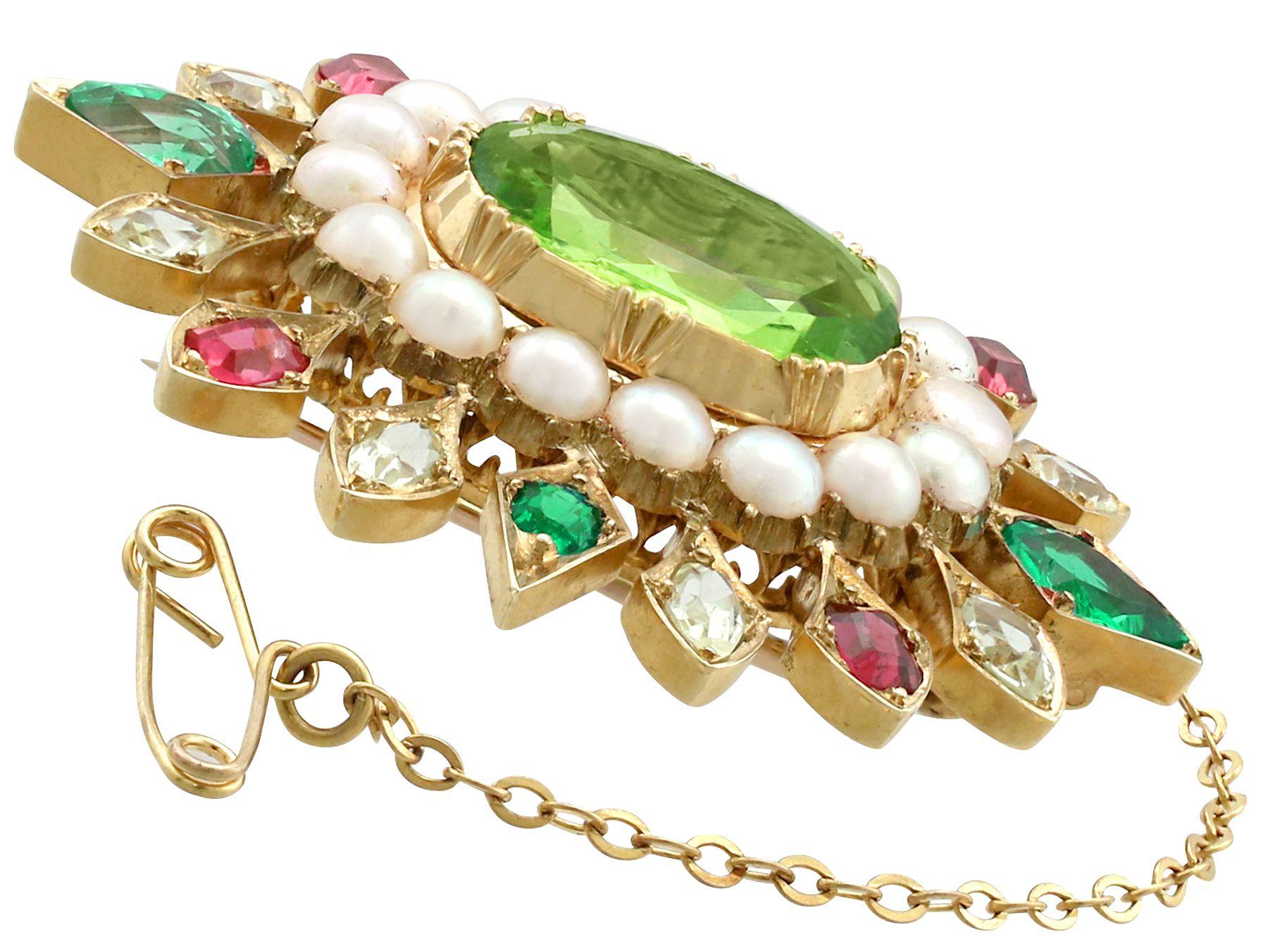 A stunning 4.35 carat peridot, 2.56 carat emerald and sapphire, seed pearl and 18 karat yellow gold brooch; part of our diverse antique jewelry collections.

This stunning, fine and impressive antique gemstone brooch has been crafted in 18k yellow