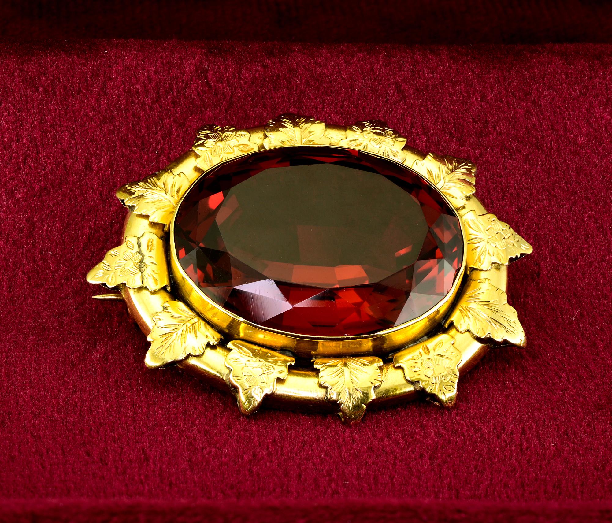 This beautiful Victorian period large brooch is 1880 ca
Skillfully hand crafted of solid 18 Kt gold
Marvelous leaf work around the frame detailed with carving
Centrally set with a stunning rich Red Orange intense and lively, rather rare color for