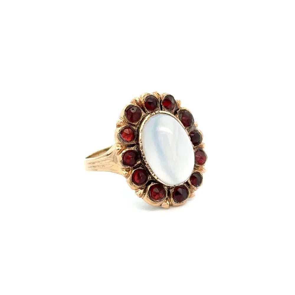 Simply Beautiful Finely Detailed Early Victorian Rare Moonstone and Garnet Gold Cocktail Ring. Centering a securely Hand set 5 Carat Moonstone, surrounded by glued Garnets, weighing approx. 0.75tcw. Ring Size 8, we offer ring resizing. Hand crafted