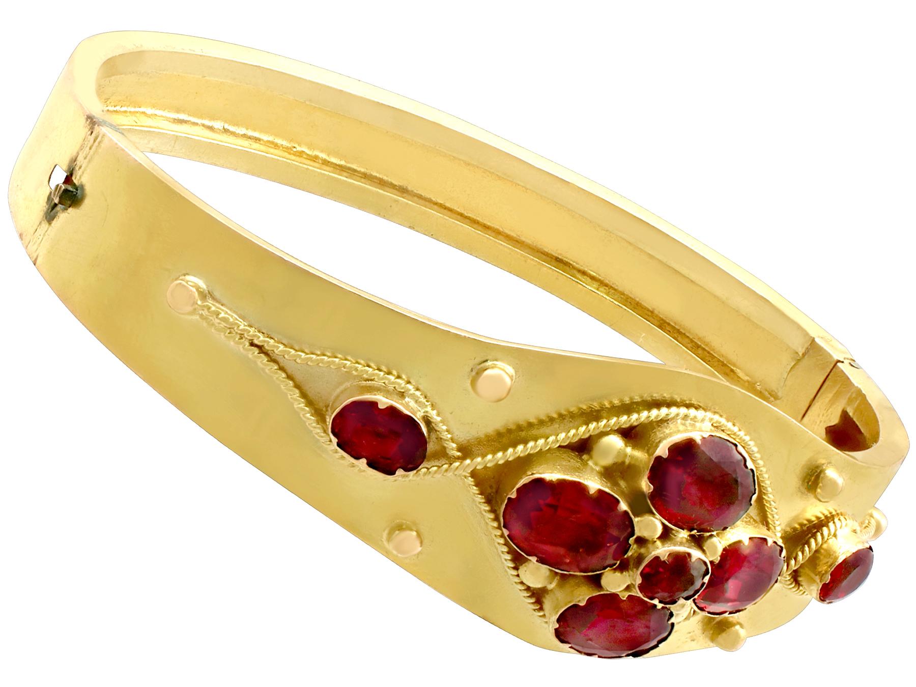 A fine and impressive antique Victorian bangle in 18k yellow gold, embellished with 5.24 carat garnets - boxed; part of our bangle and bracelet collection.

This fine and impressive Victorian bangle has been crafted in 18k yellow gold.

The simple