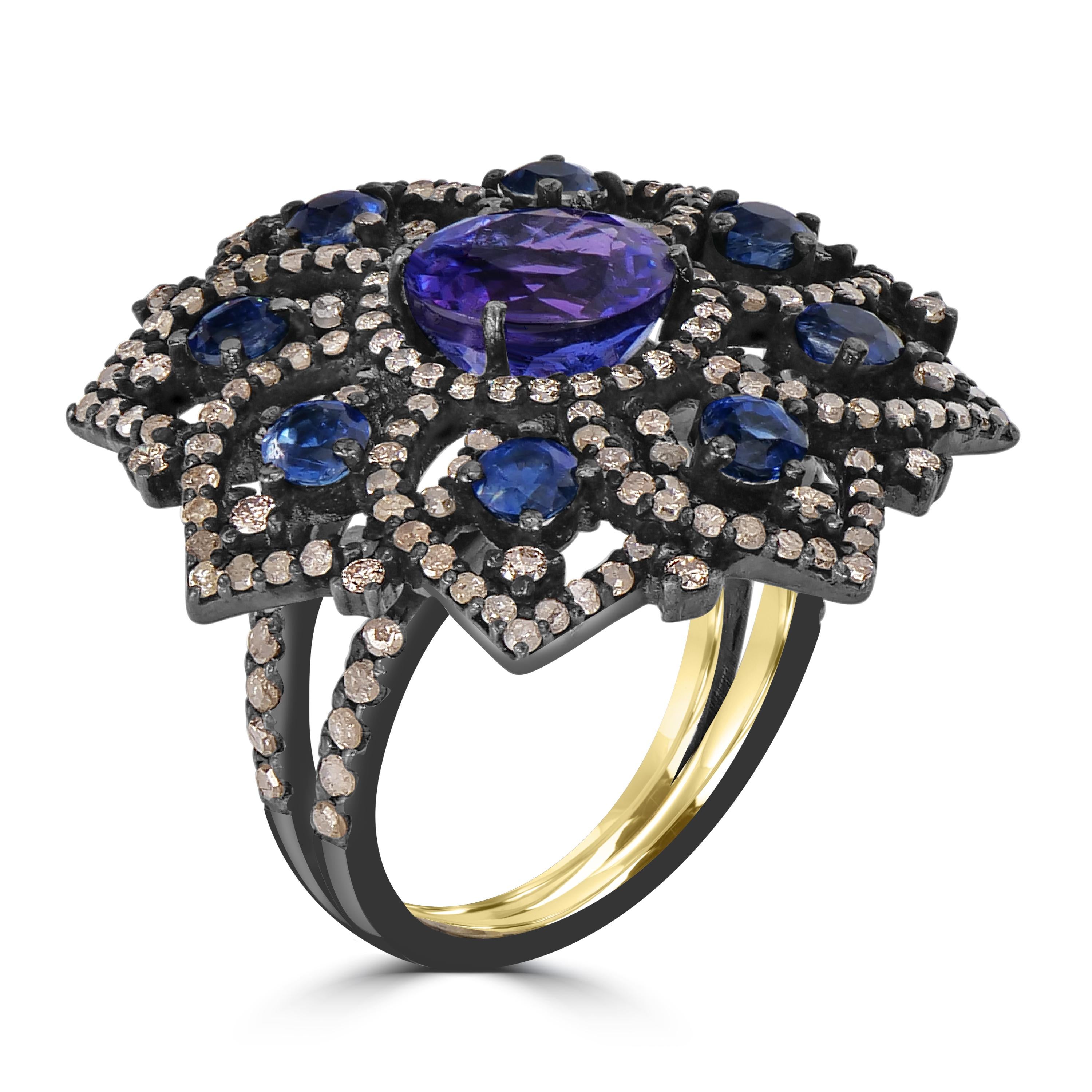 Introducing our breathtaking Victorian Floral Split Shank Ring, a true masterpiece that combines the enchanting beauty of tanzanite, kyanite, and diamonds. Crafted with precision in 7.2 grams of metal, this ring is an embodiment of timeless elegance