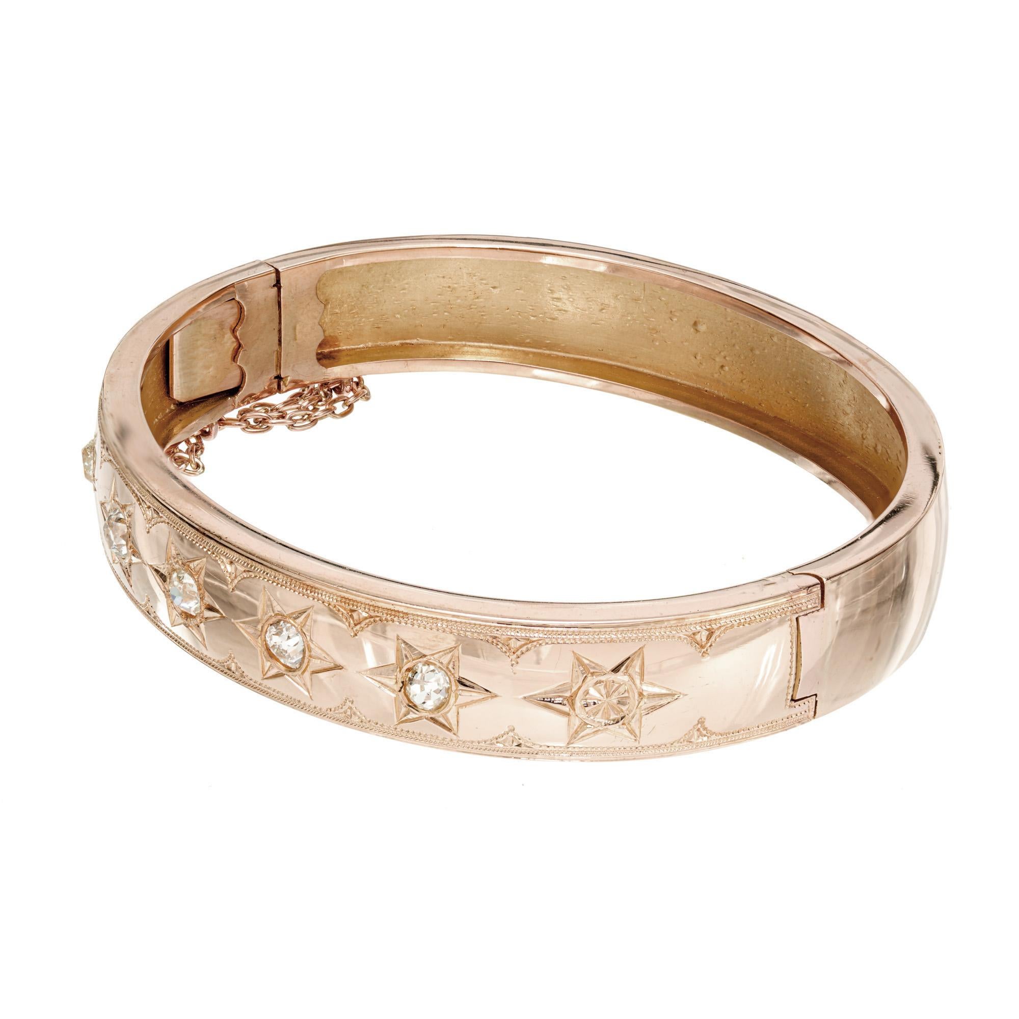 Handmade 11mm wide diamond 14k rose gold bangle bracelet from the Victorian era. circa 1850. 5 old mine cut diamonds, in 6 pointed star settings. Soft-medium rose color gold. Catch with a safety chain. 

5 old mine cut diamonds, H-I VS-SI approx.