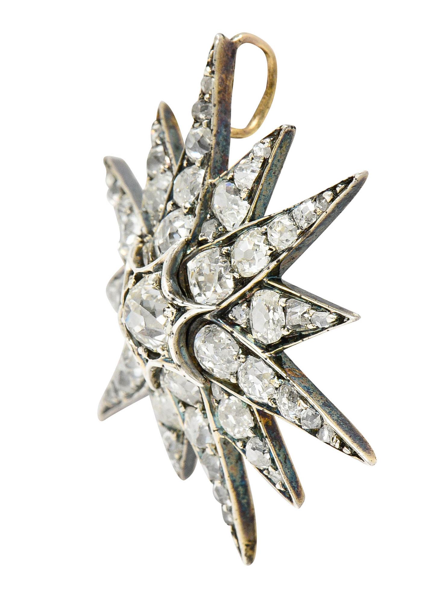 Pendant is designed as a tiered starburst motif with twelve undulating rays

Centering an old mine cut diamond weighing approximately 0.80 carat - I/J color with SI1 clarity

Surrounded by old mine, old European, rose cut diamonds

Weighing in total