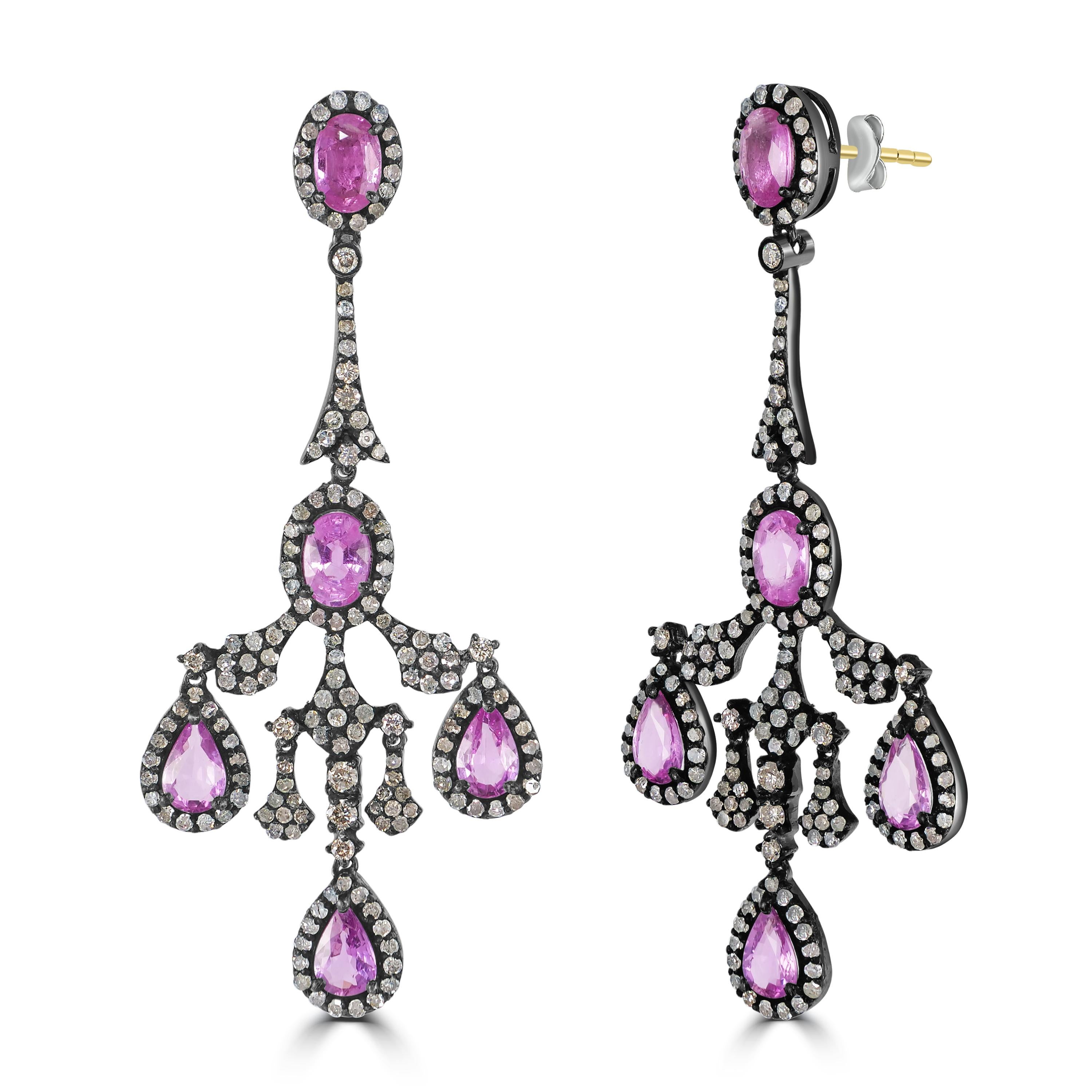 Drape yourself in the elegance of yesteryears with these Victorian 6.6 Cttw. Pink Sapphire and Diamond Chandelier Earrings. Each earring is a delicate confection of oval pink sapphires set in a diamond halo on a black rhodium surface, reminiscent of