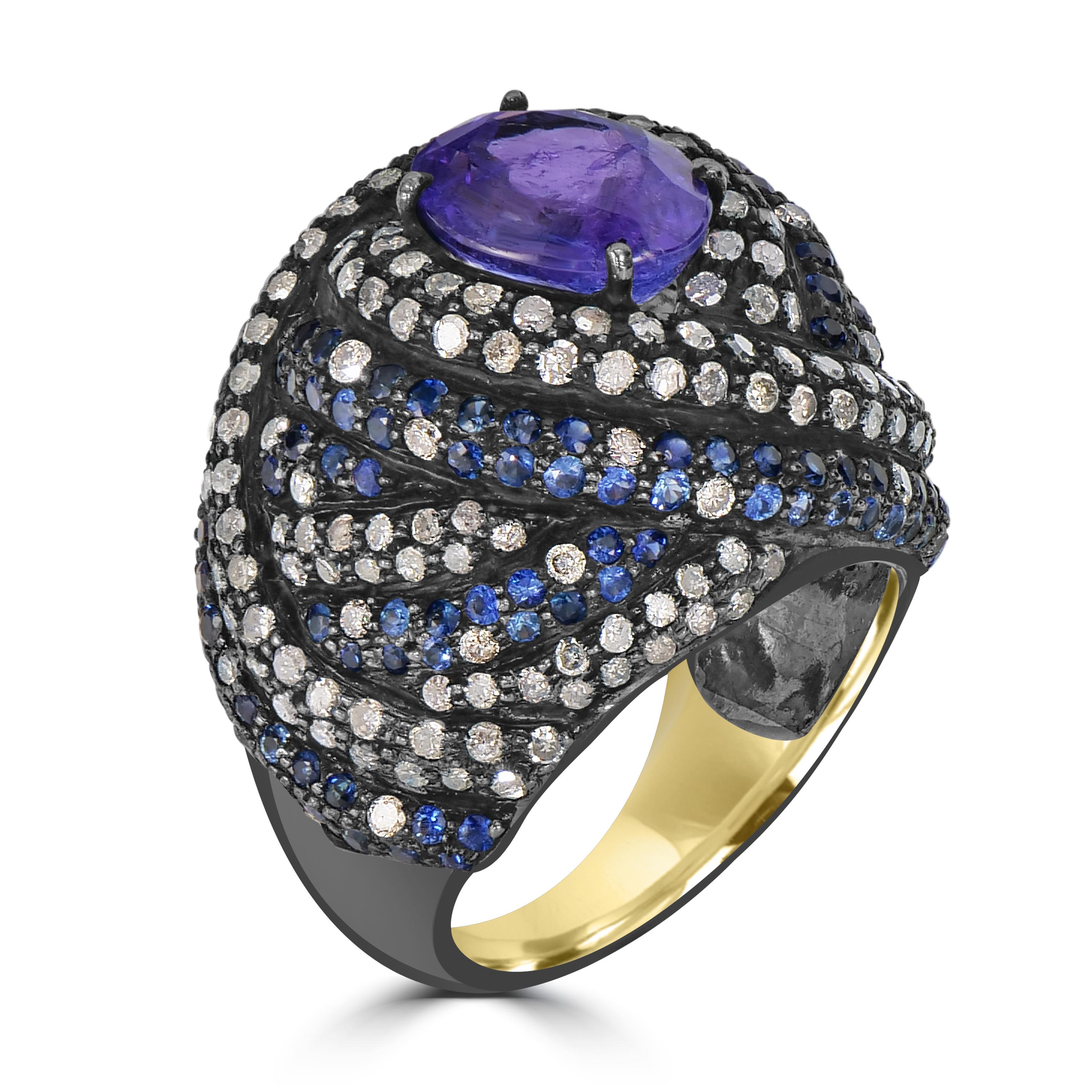 Embark on a journey of unparalleled luxury with this exquisite Dome Ring, a masterpiece that seamlessly blends the richness of tanzanite, the sparkle of diamonds, and the allure of blue sapphires. The ring's crown jewel is a captivating tanzanite at