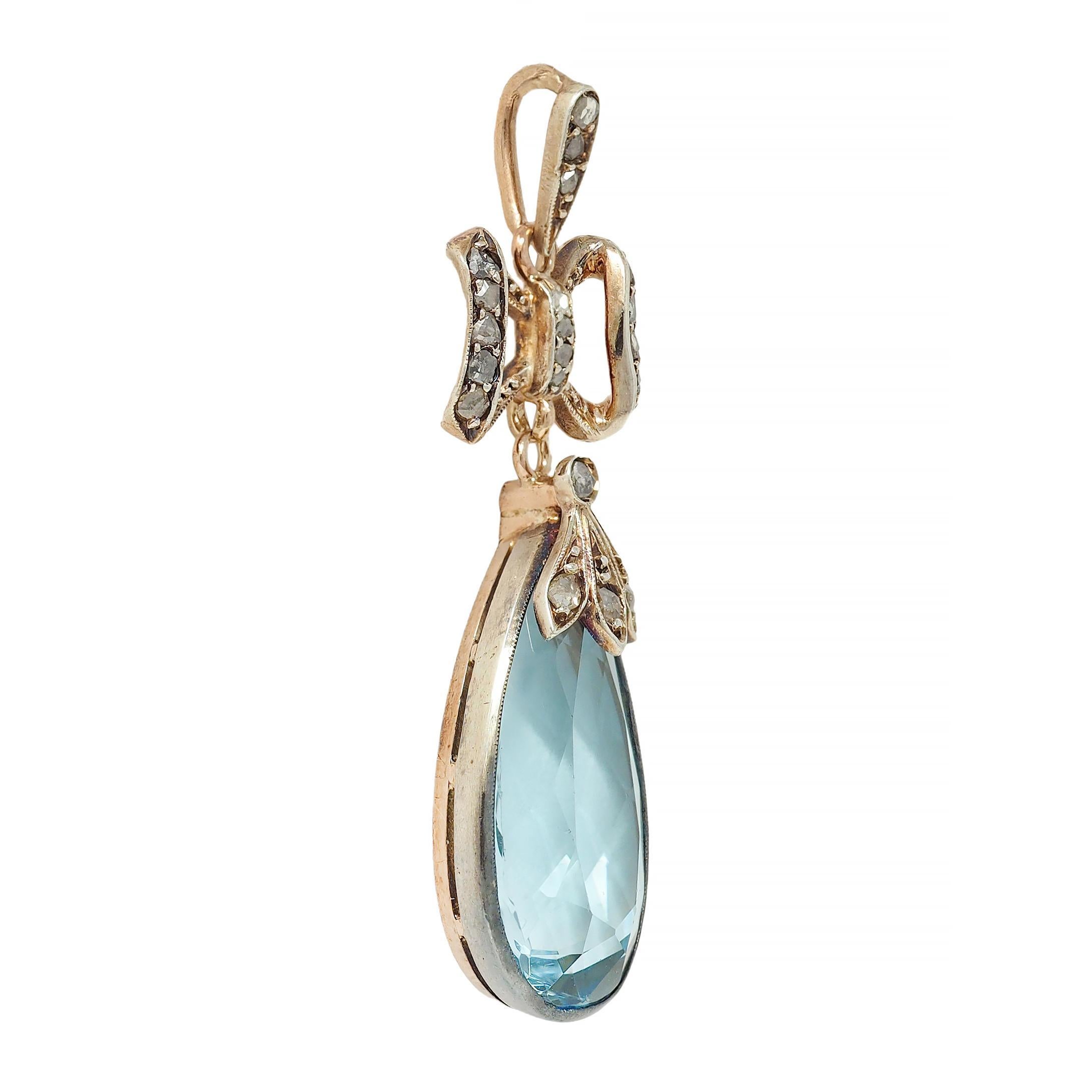 Designed as a bow motif surmount suspending an articulating aquamarine drop
Pear cut and weighing approximately 7.10 carats - transparent light blue
Bezel set with foliate motif cup - bead set throughout with rose cut diamonds
Weighing approximately