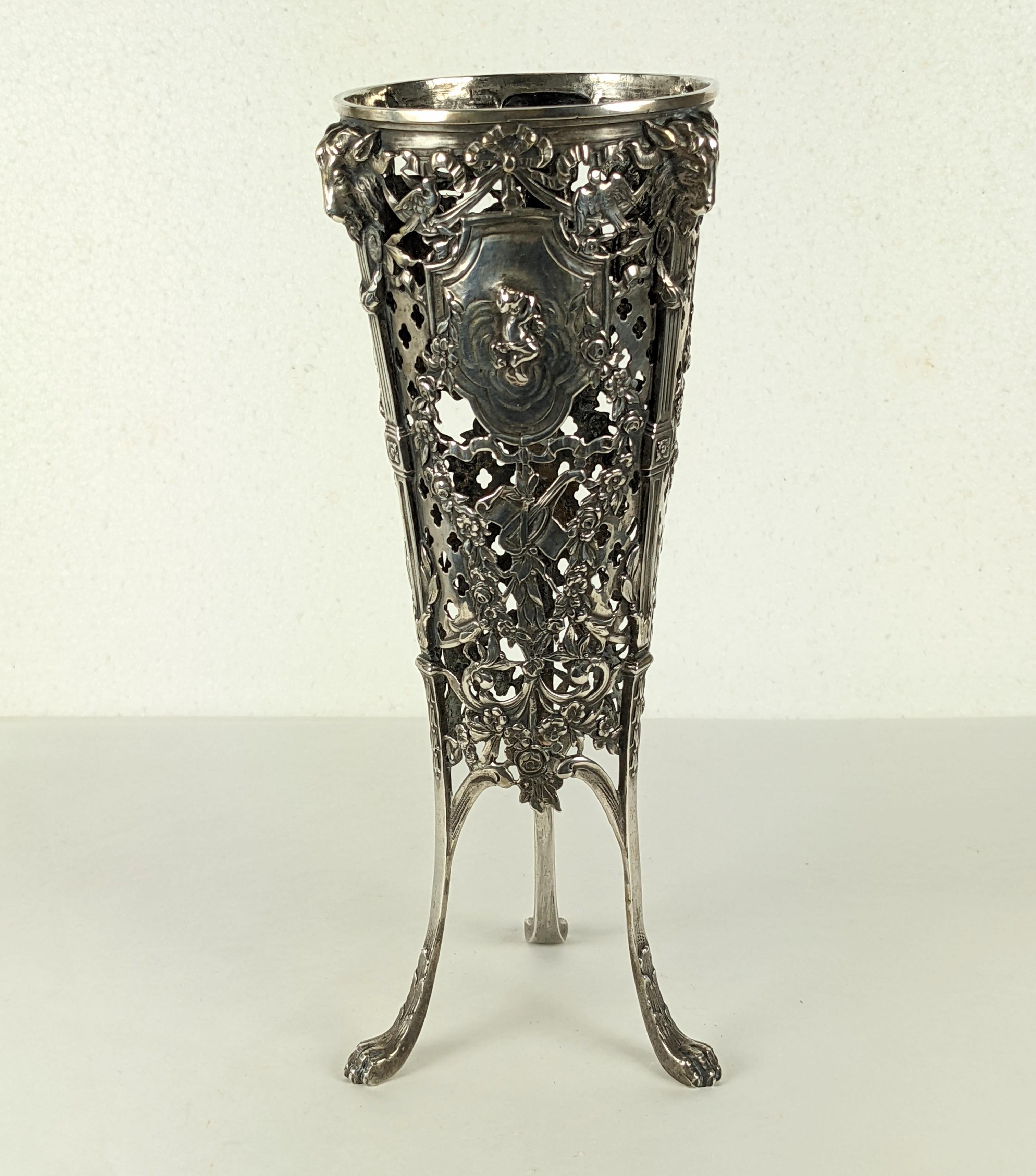 Late 19th century heavy gauge 800 silver vase base with repousse and open work motifs. Motifs include putti, rams heads, bird and swags. The glass liner would be tapered and is missing. Germany circa 1900. 
8.75