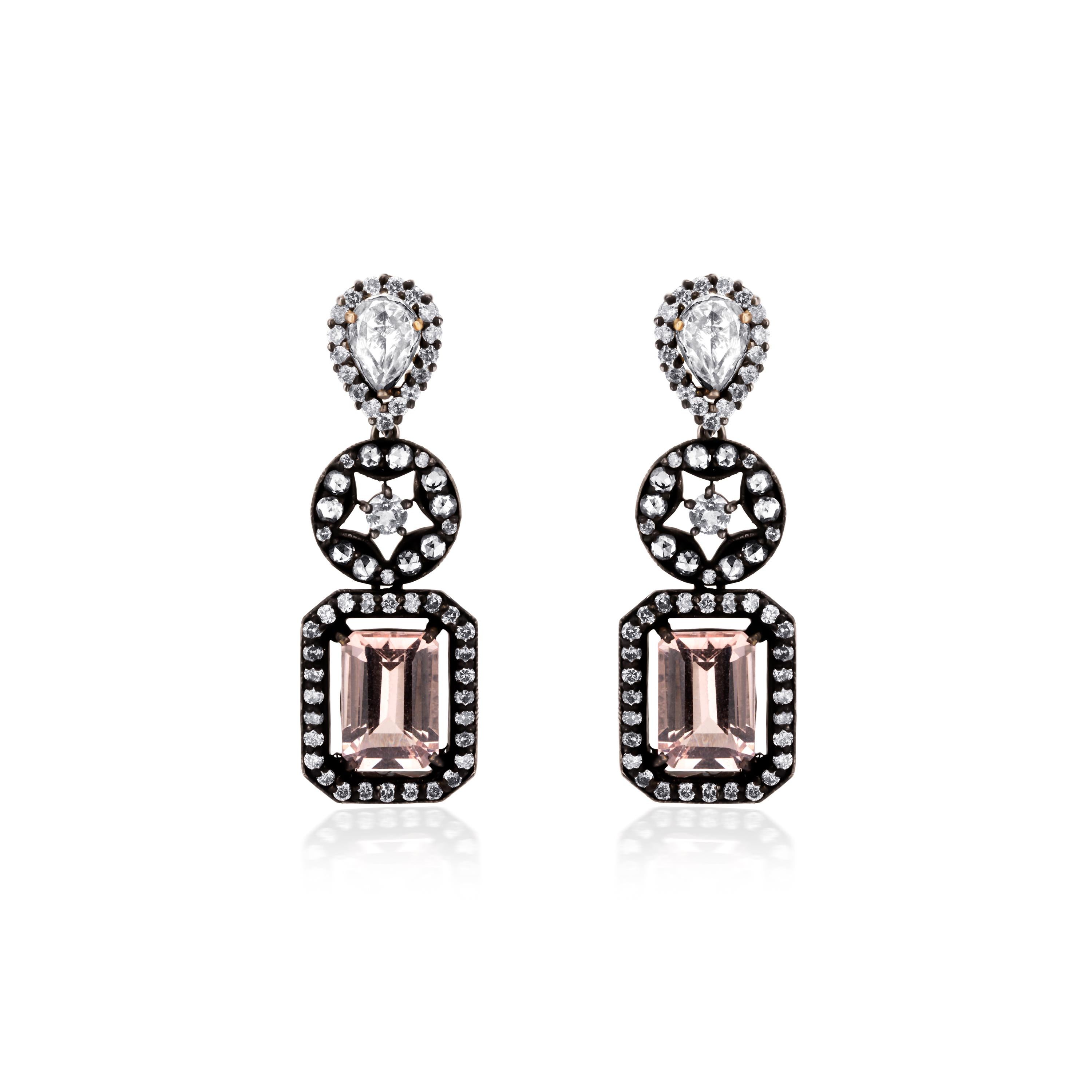 These magnificent Victorian drops, crafted in 18K gold and 925 sterling silver, each feature a graduating trio of differently shaped frames that culminates with gleaming morganites, weighing 5.39Cts stationed in a pierced frame of diamonds. The