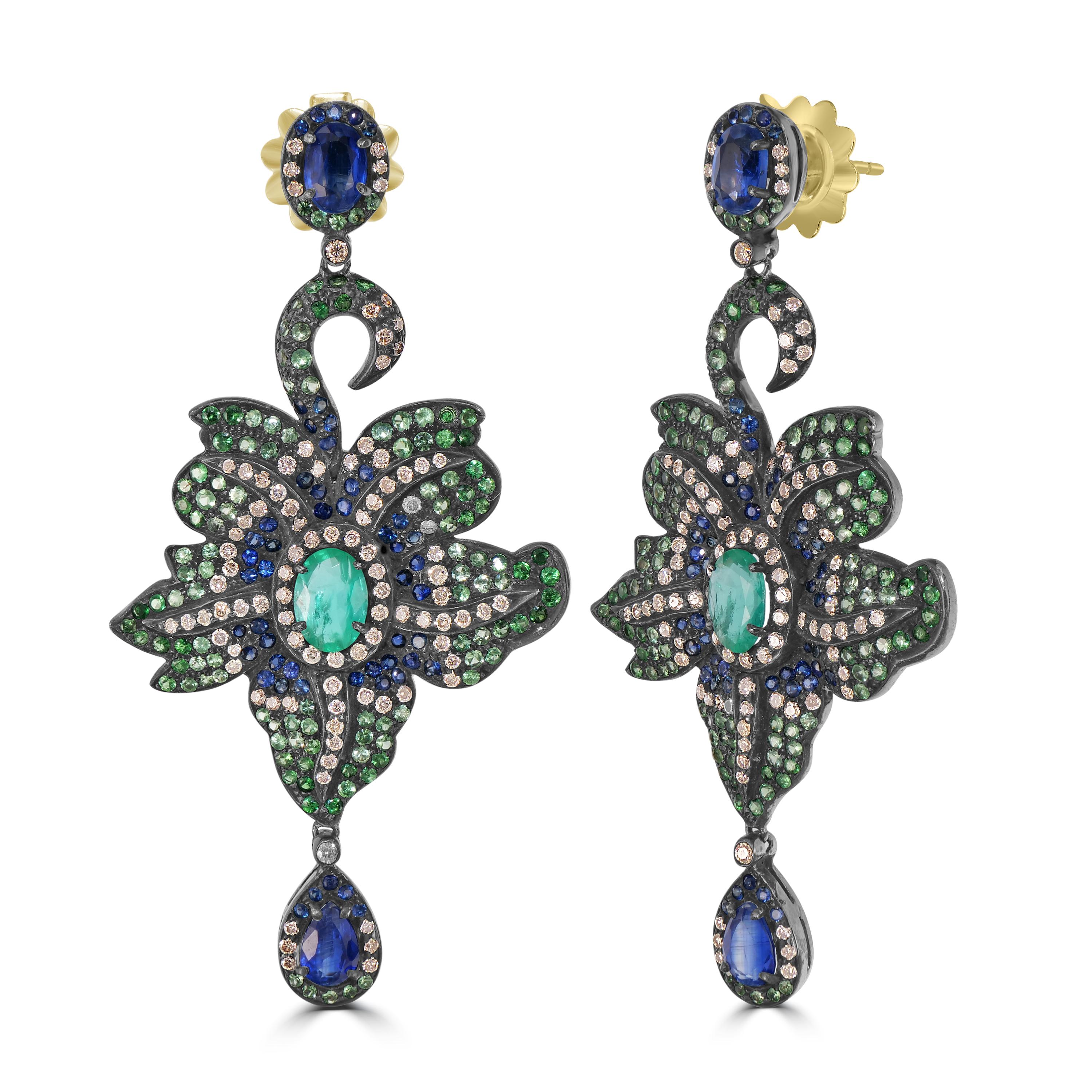 Behold the resplendent Victorian 8.75 Cttw. Sapphire, Emerald, Tsavorite, Kyanite, and Diamond Dangle Earrings—a dazzling symphony of colors and craftsmanship.

The surmount of these earrings features an oval kyanite, embraced by a spectacular halo