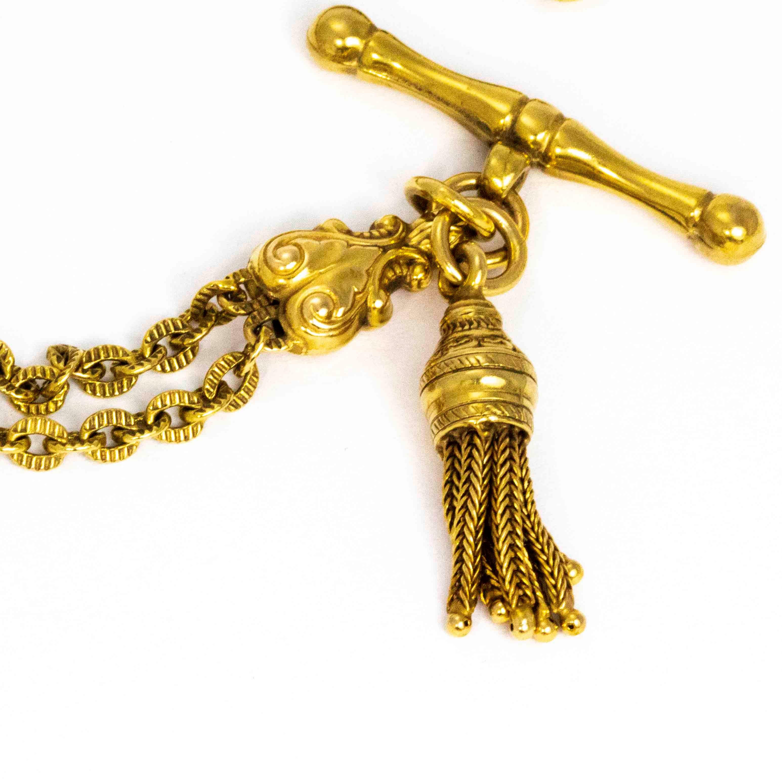 Thos gorgeous bracelet boasts so much detail. The t bar and dog clip appear at both ends of the chain. The other main details on this chain are the cute tassel that hangs right next to the t bar and the stunning scroll and plaque links that are in