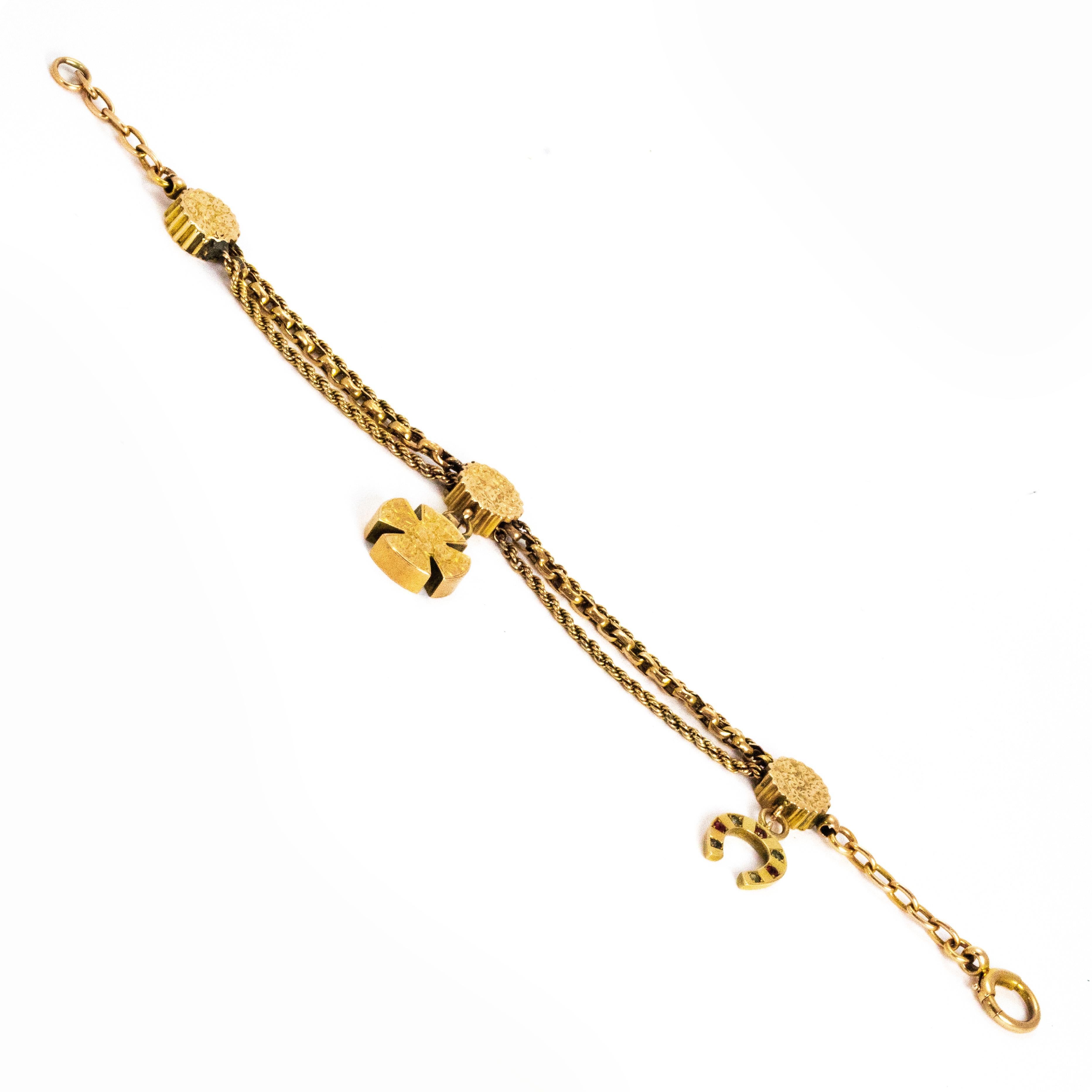 A wonderful antique Victorian Albertina bracelet. Set with a horse shoe charm inlaid with red and green stones, and an ornately detailed Maltese cross. Modelled in 9 carat yellow gold.

Length: 20cm