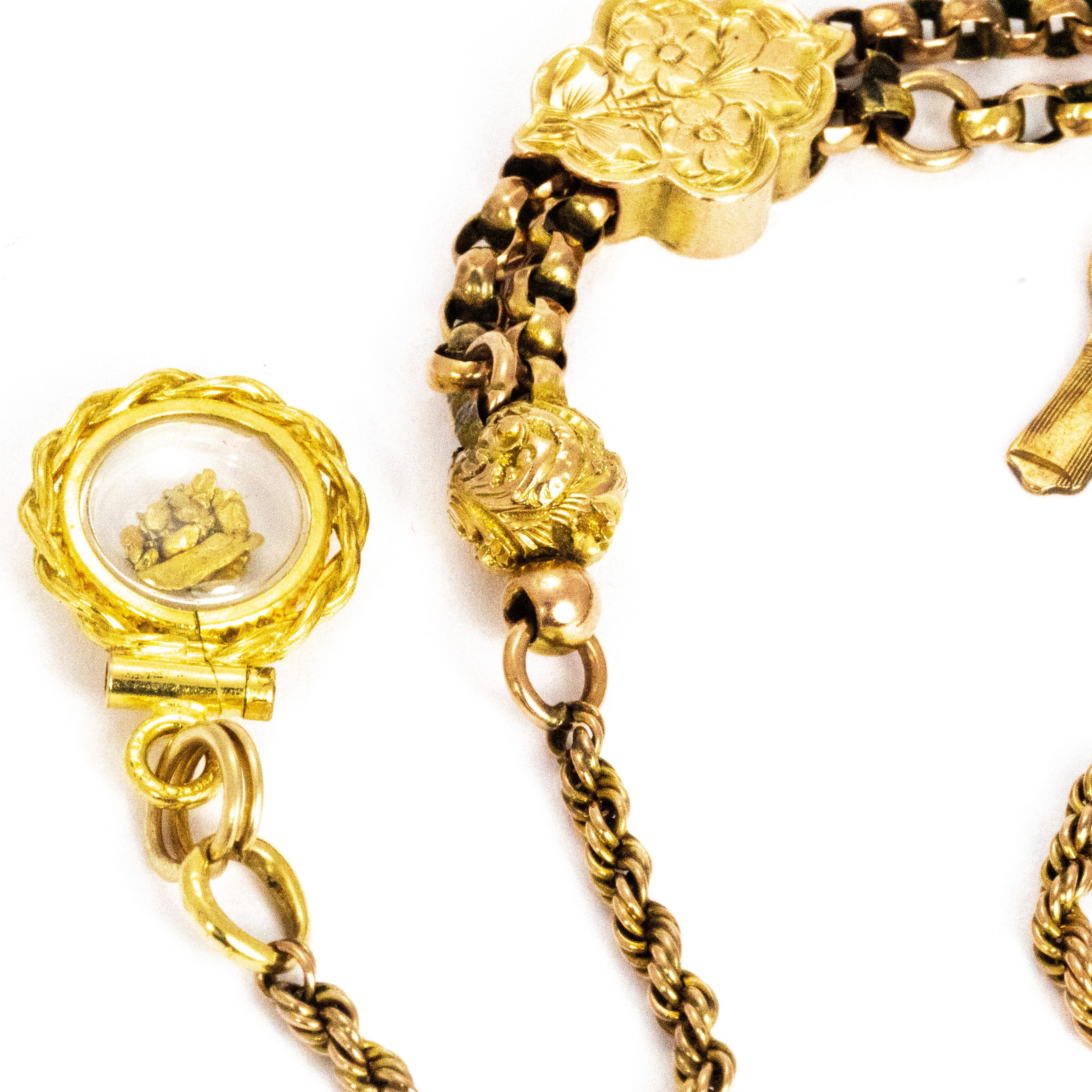 The charms on this bracelet are absolutely darling. The rope twist chain holds a glass compartment which holds gild nuggets and the other side holds the dog clip. At he centre is a double chain with a sliding gold bead and a sweet little gent charm.