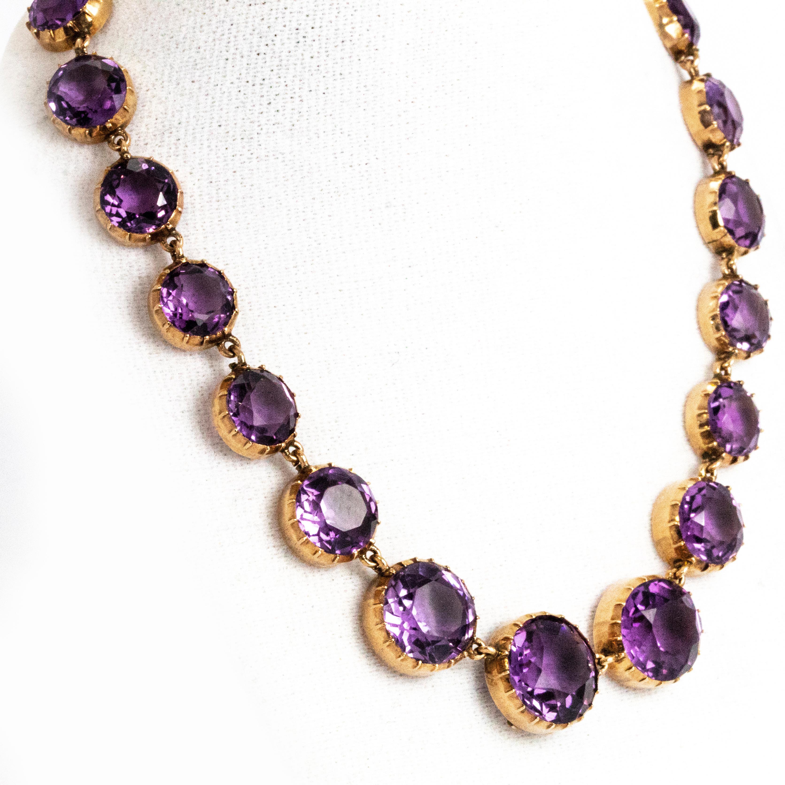This wonderful antique mid-Victorian Riviere necklace is fully set with beautiful round-cut graduated amethysts. The stones have great height and sit elegantly in uniform pie-crust settings. There is a great pendant loop which folds behind the