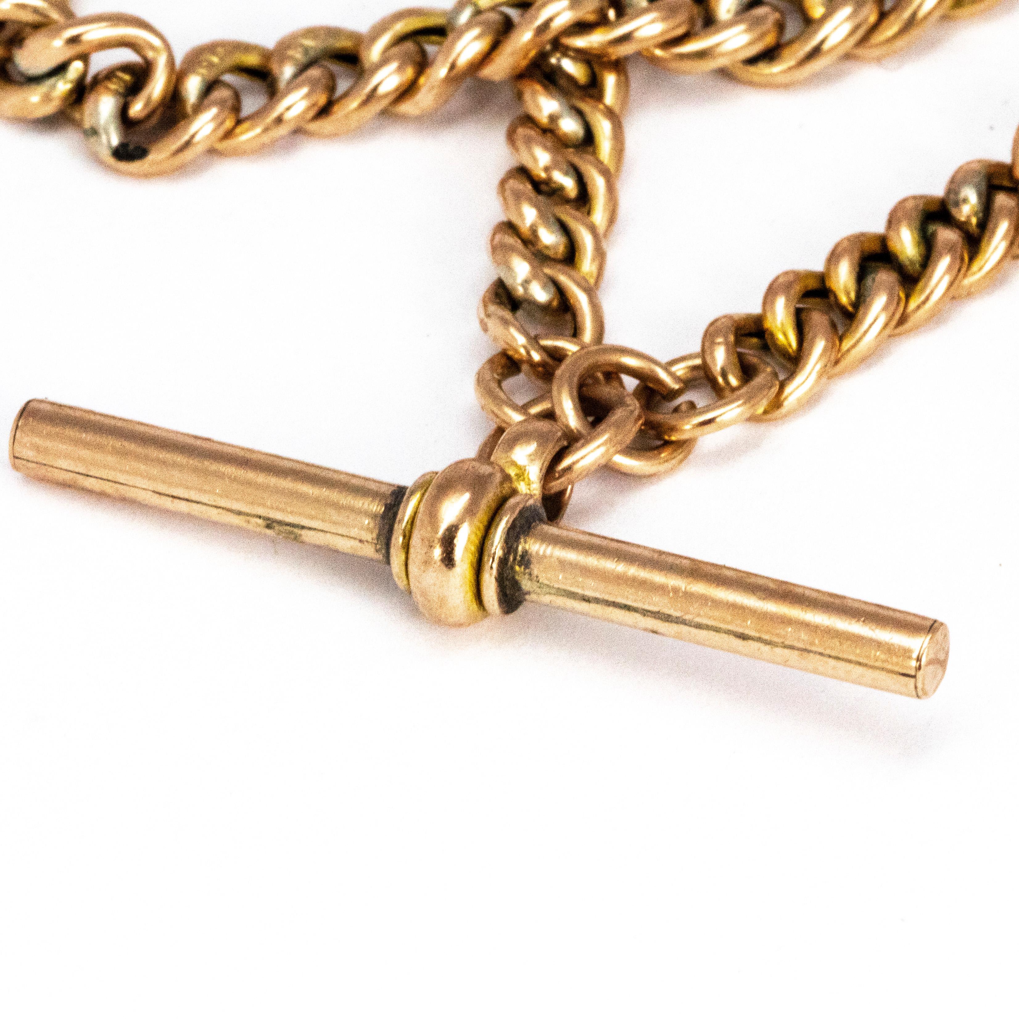 This is a traditional chunky 9ct gold double albert chain. The chain features a t-bar and two dog clips. At the end of the chain is a dog clip to attach a charm or a watch. 

Length: 41cm 
Width: 6mm 