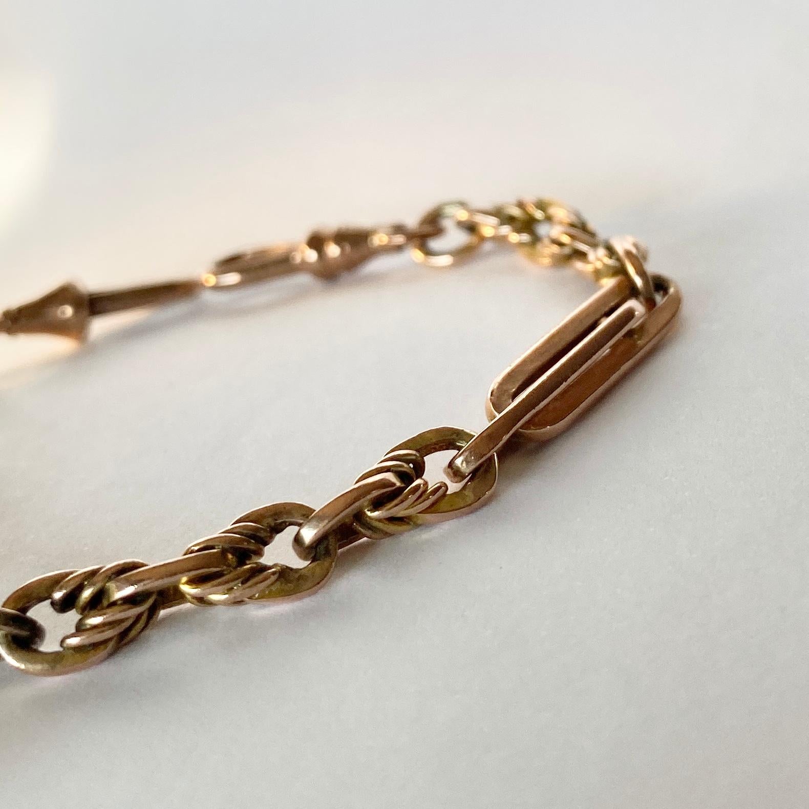 This gorgeous bracelet has highly decorative links in it. One of the styles resembles the trombone link and the other is layered, knotted and twisted. This bracelet also holds a t-bar. Modelled in 9ct gold.

Length: 19cm 
Width: 5.5mm 

Weight: 17g