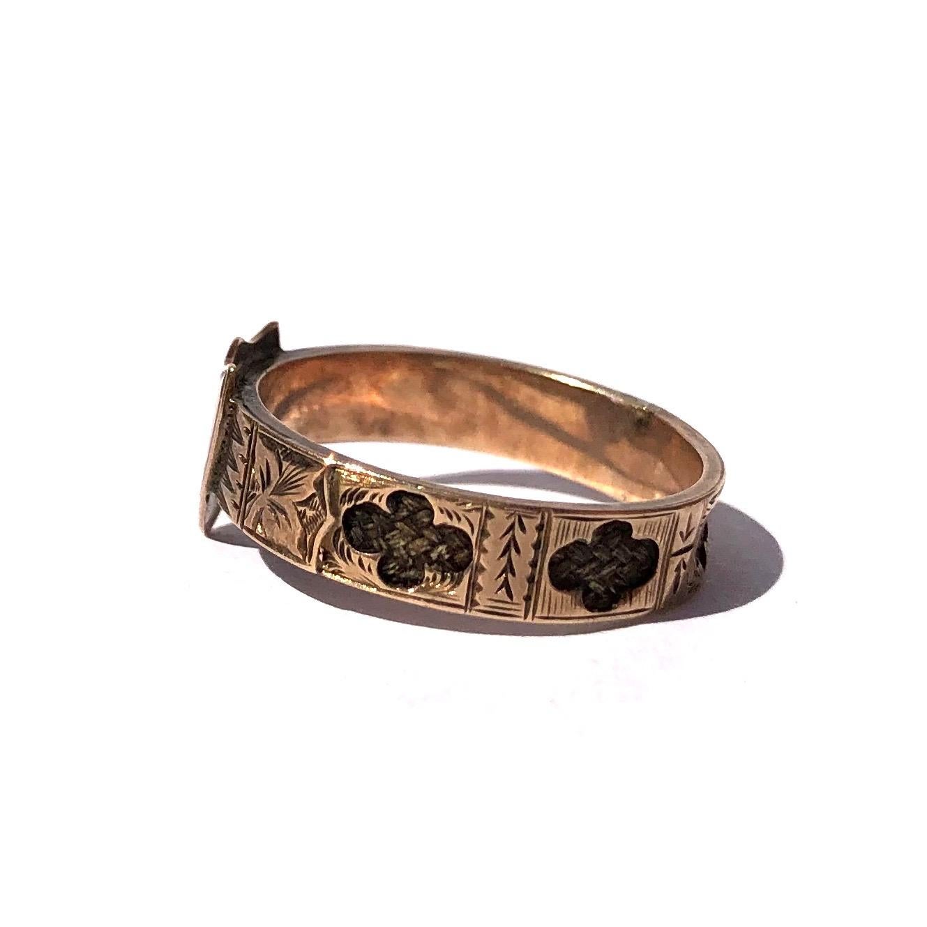 The shield at the front of this band has fancy initials finely engraved into it reading 'P.H.E'. The band itself is made up of panels with more gorgeous engraving all the way around and cut out panels revealing braided hair underneath. 

Ring Size: