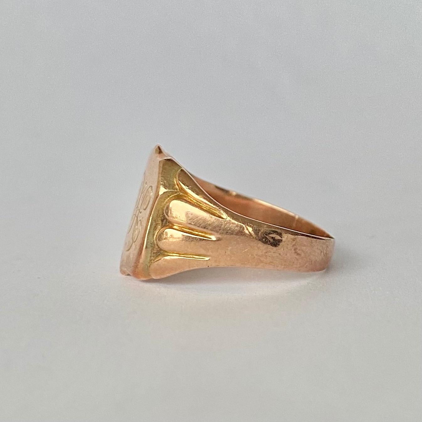 The fluid scroll font which reads 'FH' is finely engraved onto the main shield panel of this ring and on the underside is the letters 'NH'. The chunky shoulders have scalloped detail and carry on down into a plain band modelled in 9ct gold. 

RIng