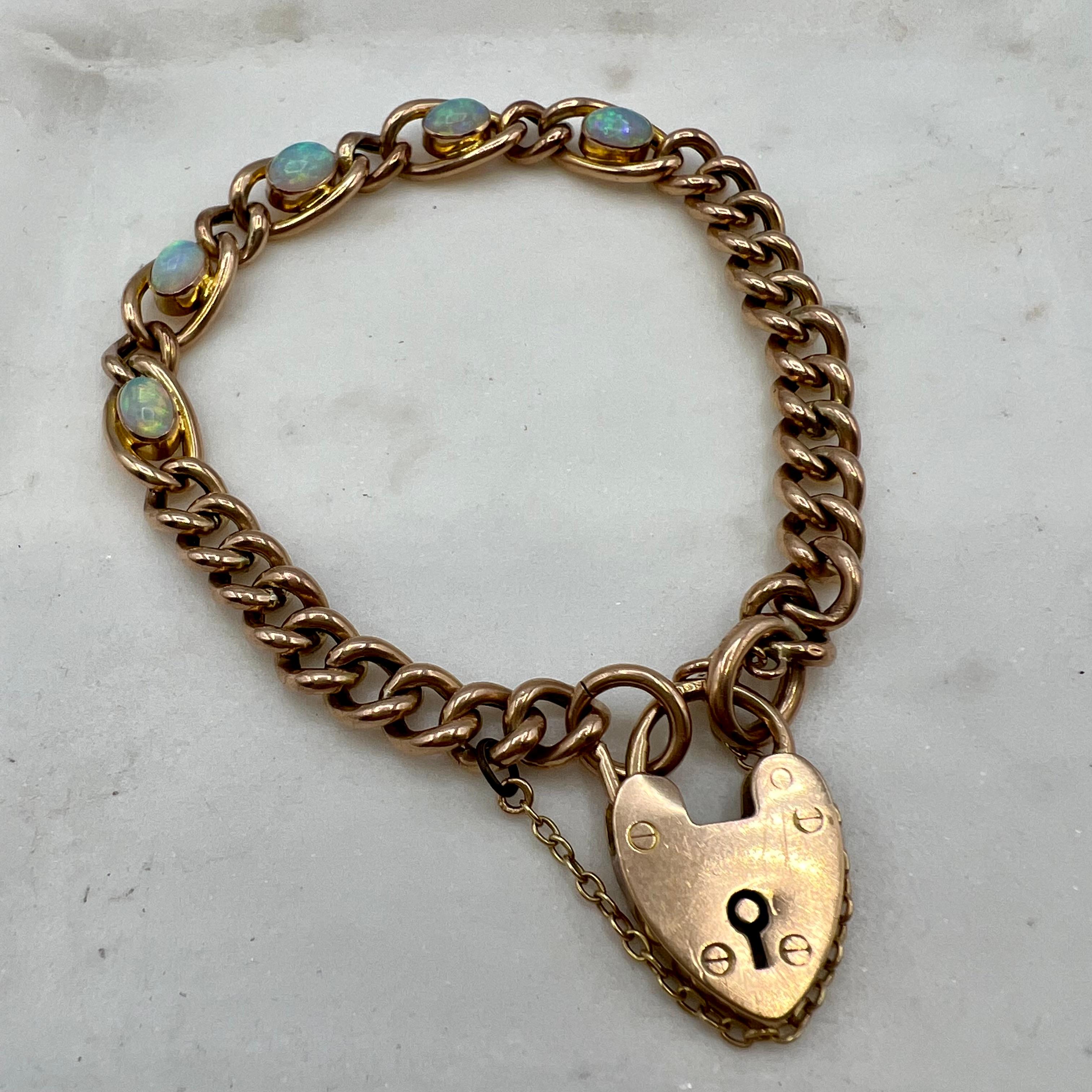 This traditional heart locket bracelet is 9 carat rose gold with a stamped hallmarks heart lock. The stones are Australian opals and are beautifully matched. This is a lovely bracelet to add to any collection.