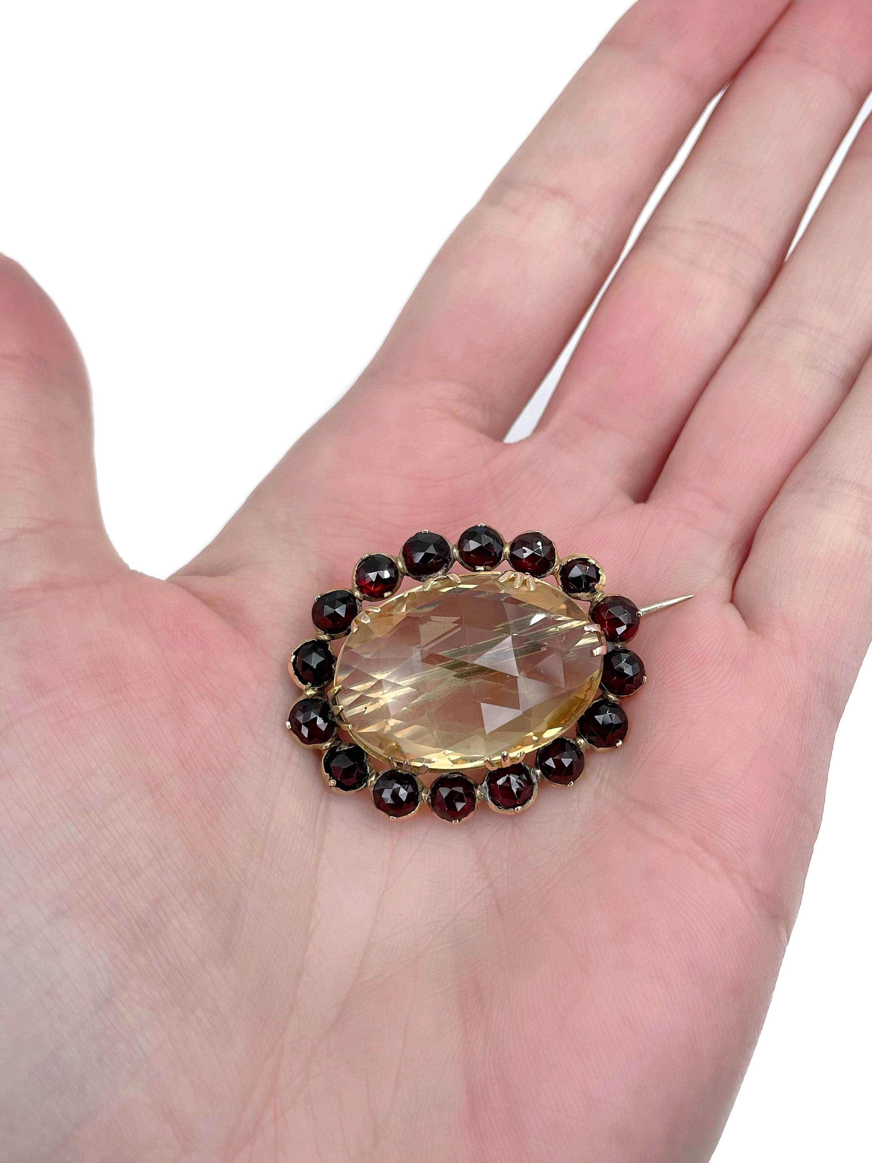 This is a Victorian oval pin brooch crafted in 9K yellow gold (needle - MET). Circa 1870.

It features faceted citrine. The gem is surrounded with rose cut garnets. 

Has a C clasp. 

Weight: 11.28g
Length (with a needle): 4.5cm
Width: 3cm

———

If