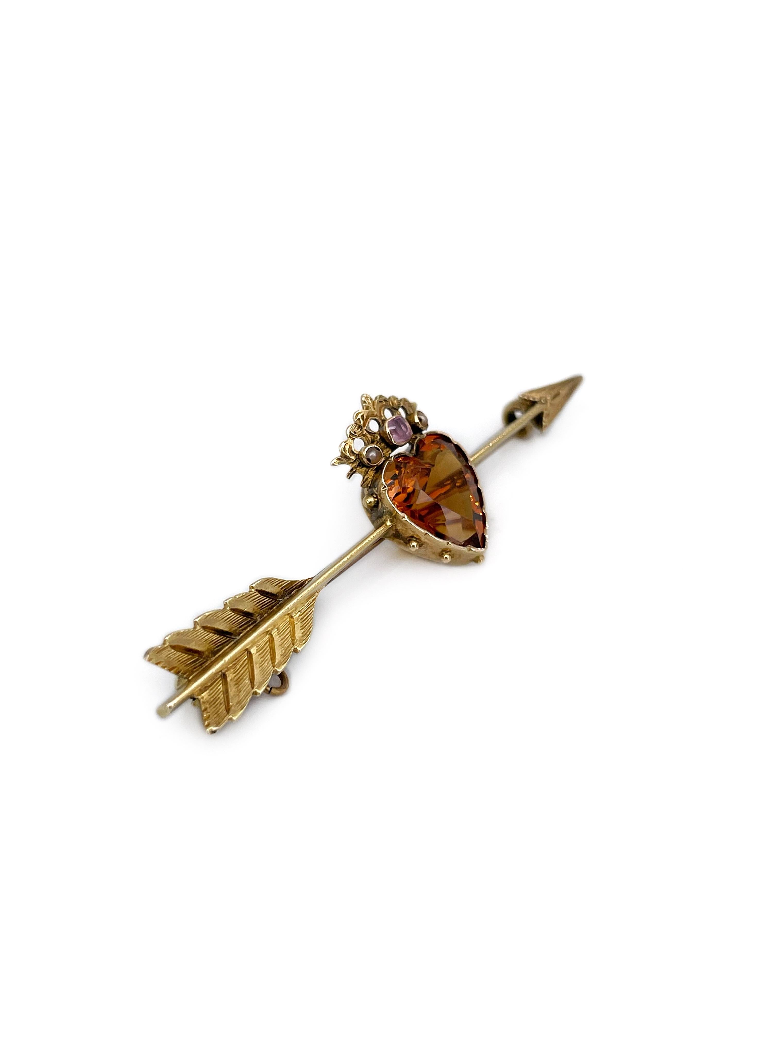 This is a magnificent antique Victorian arrow bar brooch crafted in 9K yellow gold. The piece features beautiful heart cut Madeira citrine. The crown is adorned with two seed pearls and a ruby. 

Weight: 3.04g
Length: 5cm
Heart: 1.5x0.8cm

———

If