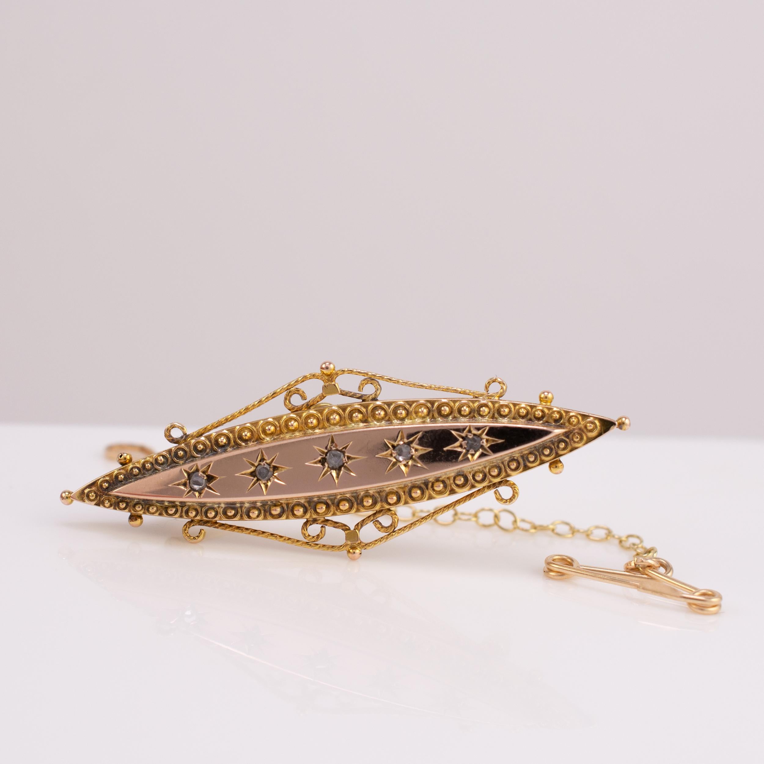 A fine quality antique diamond brooch dated Chester 1900.

The smooth rose gold platform is set with five old rose cut diamonds set in stars. The lower lip, in yellow gold, is decorated with chased circle and ball applied filigree detail Intricate