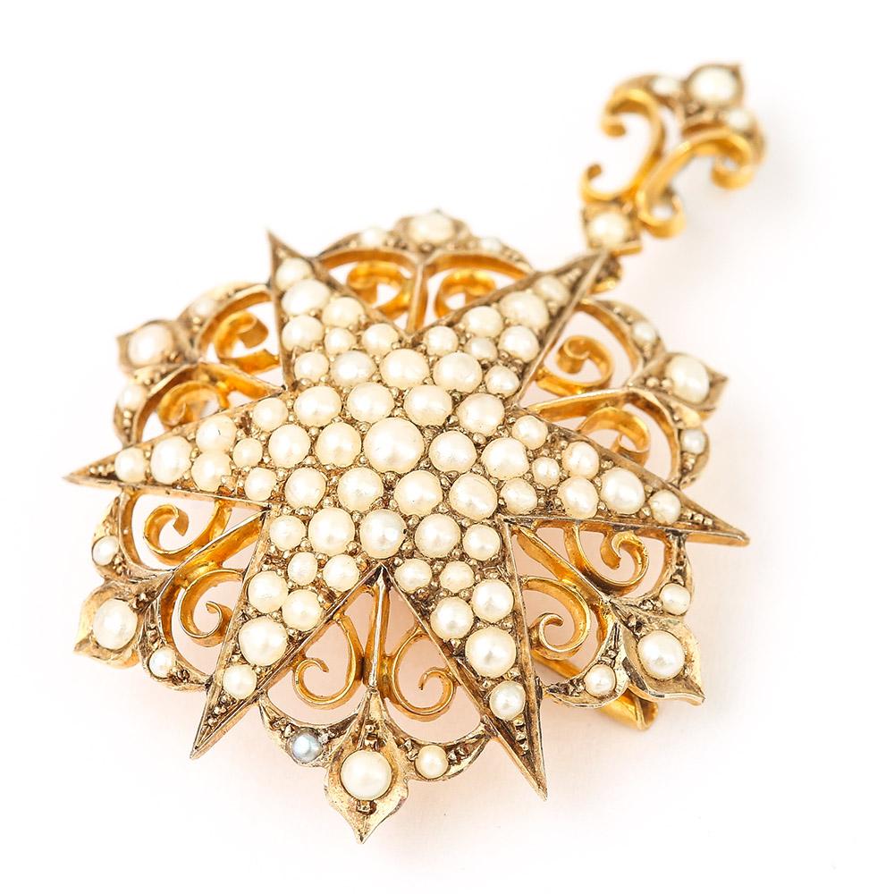 A delightful 9k yellow gold Victorian circa 1880 ornate seed pearl star pendant with scrolled gold detail. Attached is a fleur de lys style pendant loop, with a brooch fastening so this jewel has dual purpose. A lovely antique piece that comes in