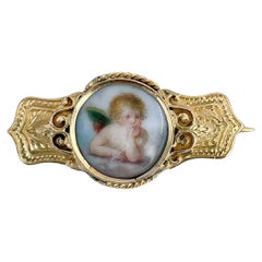 Broche victoriano de porcelana de oro de 9 quilates con retrato en miniatura de un querubín
