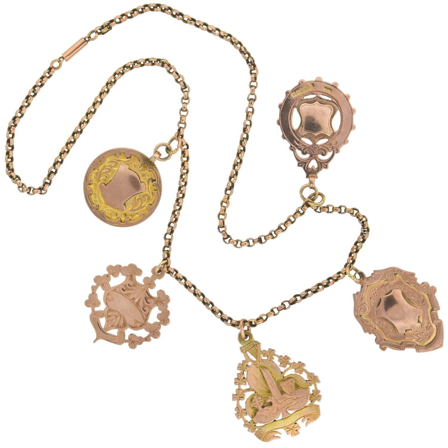A stunning and bold medallion necklace with pieces from the Victorian (ca1880s) era! This lovely compilation piece is crafted in 9kt rose gold and adorns 5 beautiful and genuine medals hanging along the center of a lovely chain. Each decorative