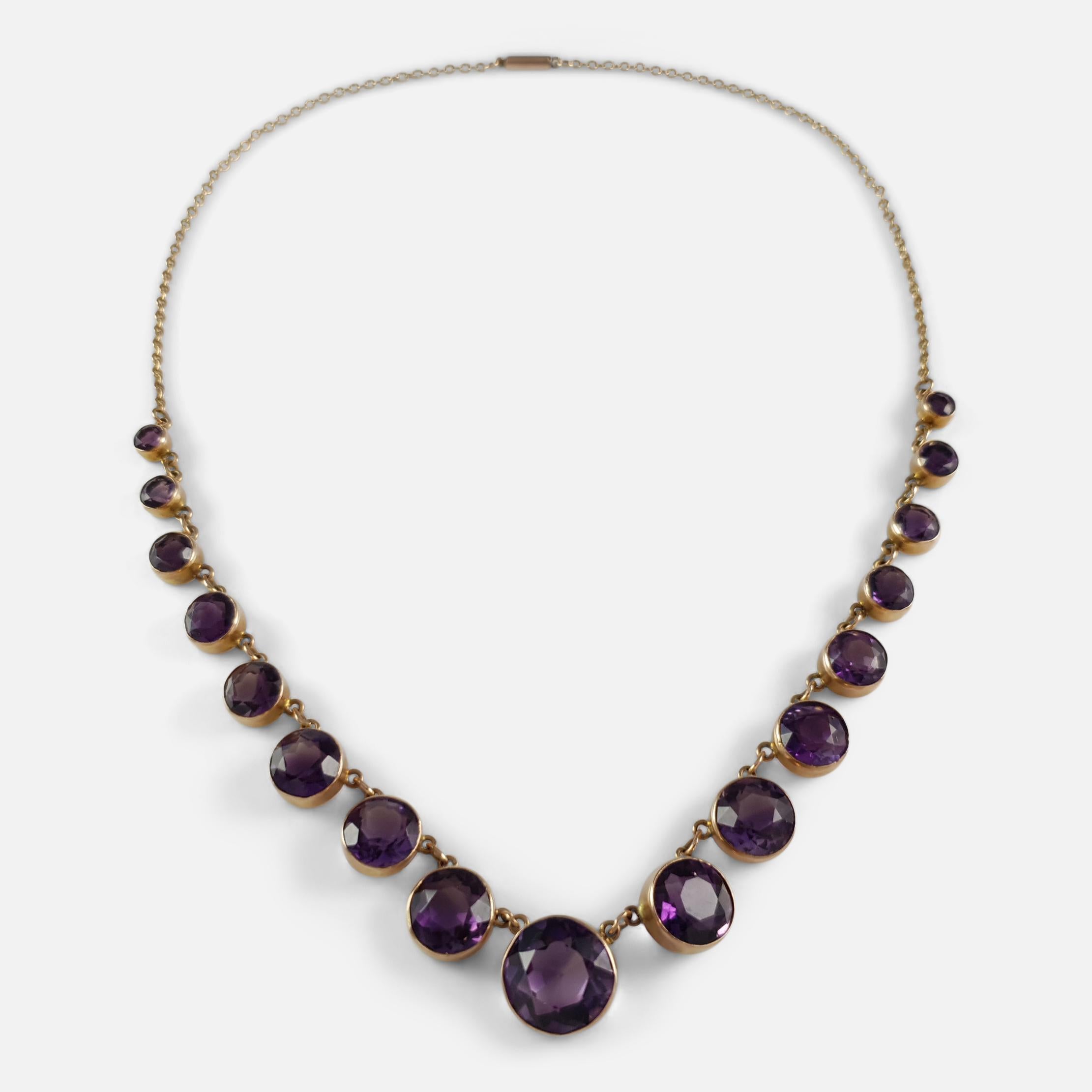 Description: - This is a stunning antique Victorian 9 karat yellow gold graduating amethyst Riviere necklace circa 1890. The amethyst necklace is collet-set to the front with a graduated line of circular-cut amethysts totalling approximately