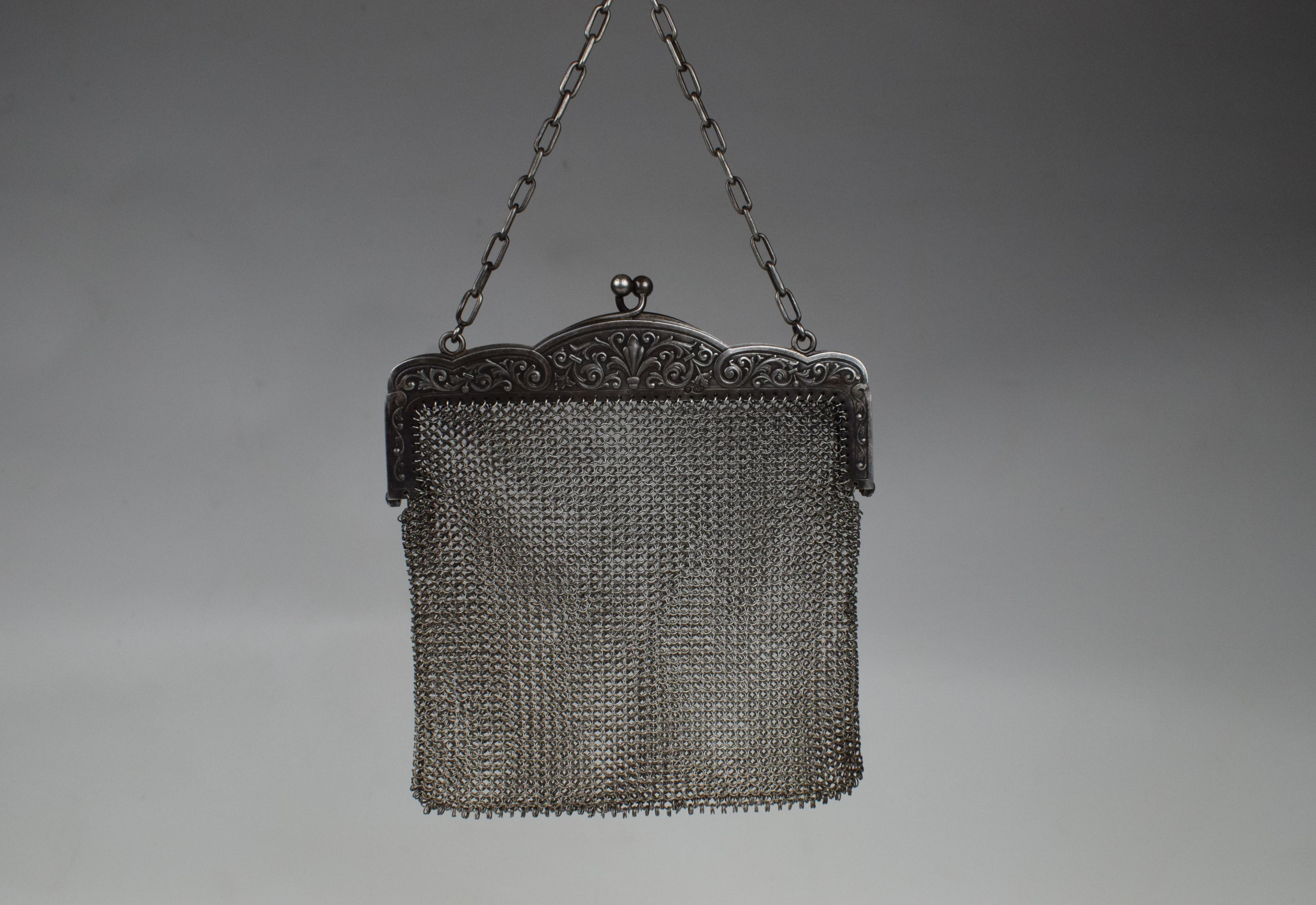 The silver chainmail purse is a stunning and luxurious accessory that embodies the opulence and craftsmanship of the era. This purse is a fine example of the Victorian obsession with intricate details and the use of precious materials.
The purse is