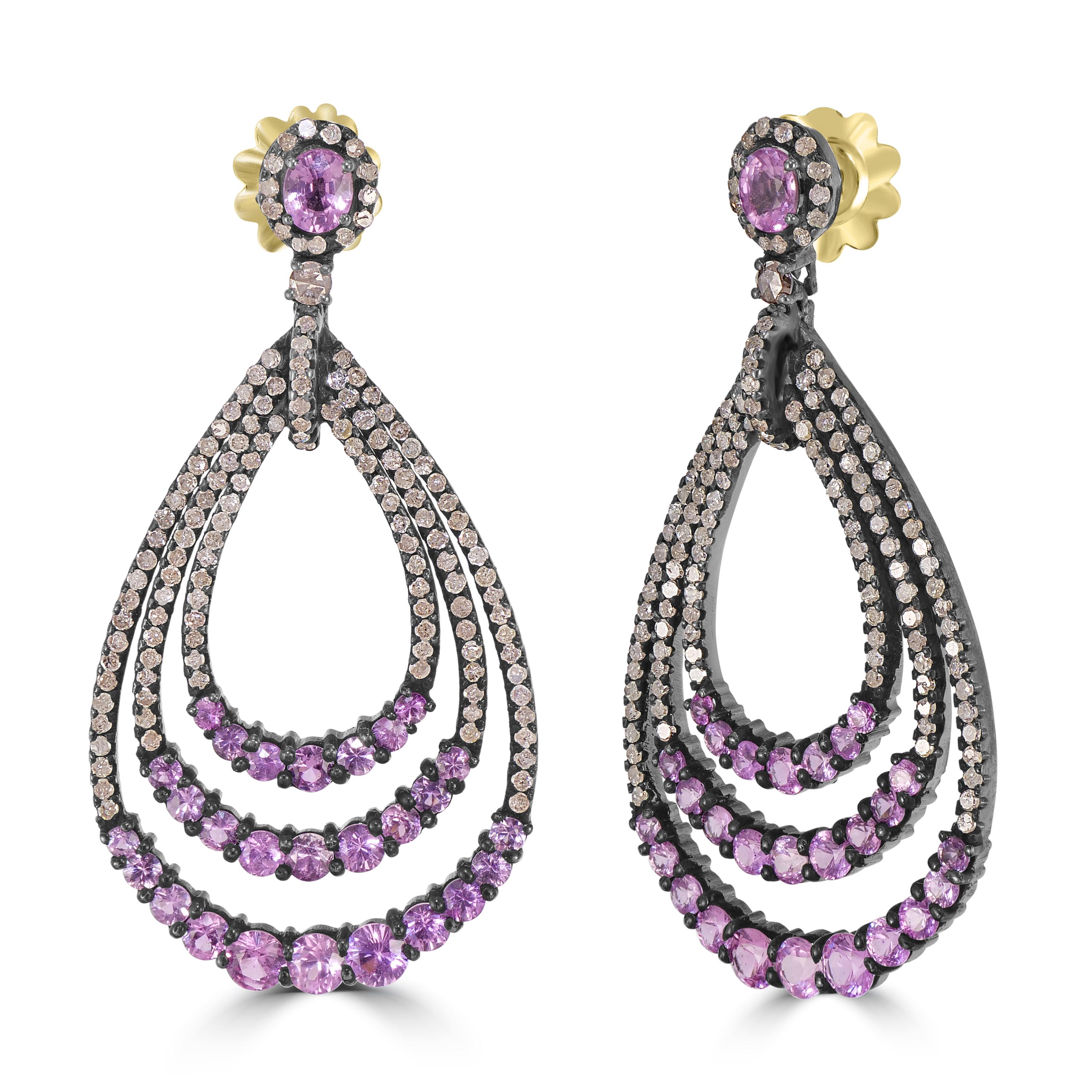 Introducing our Victorian 9.83 Cttw. Pink Sapphire and Diamond Teardrop Earrings – a dazzling testament to elegance and sophistication.

Crafted with exquisite detail, these earrings feature a captivating open-work, teardrop design adorned with