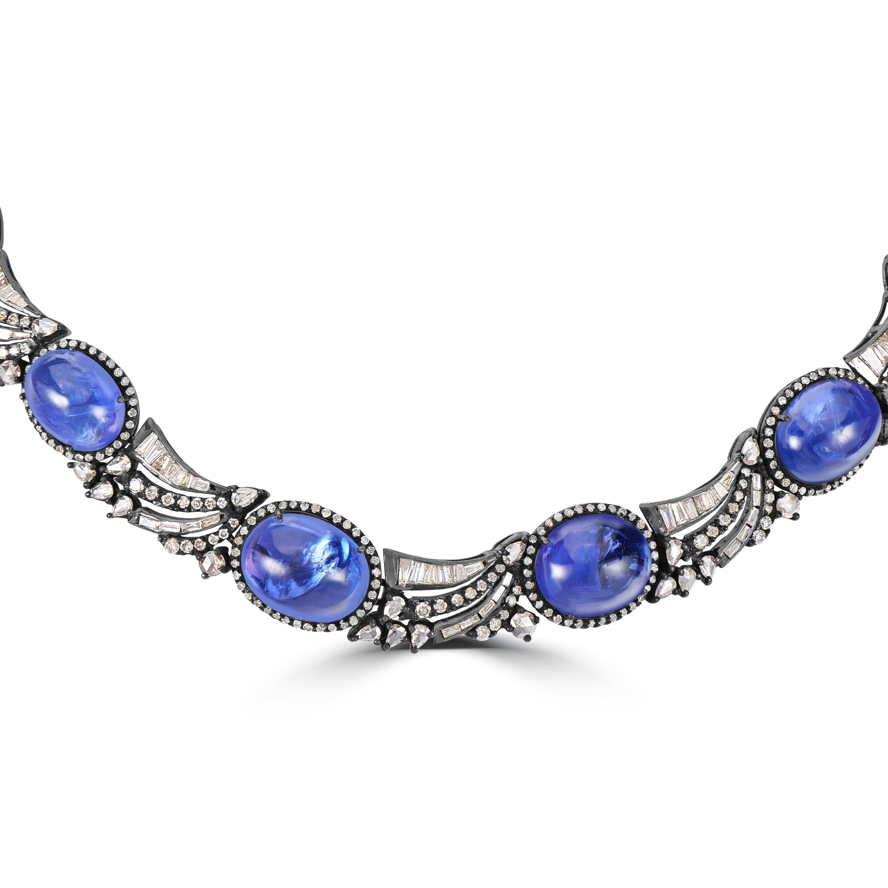Introducing our opulent Victorian 98.75 Cttw. Tanzanite and Diamond Choker Necklace, a breathtaking statement piece that exudes timeless elegance and sophistication.

This magnificent choker necklace features nine stunning oval tanzanite, each