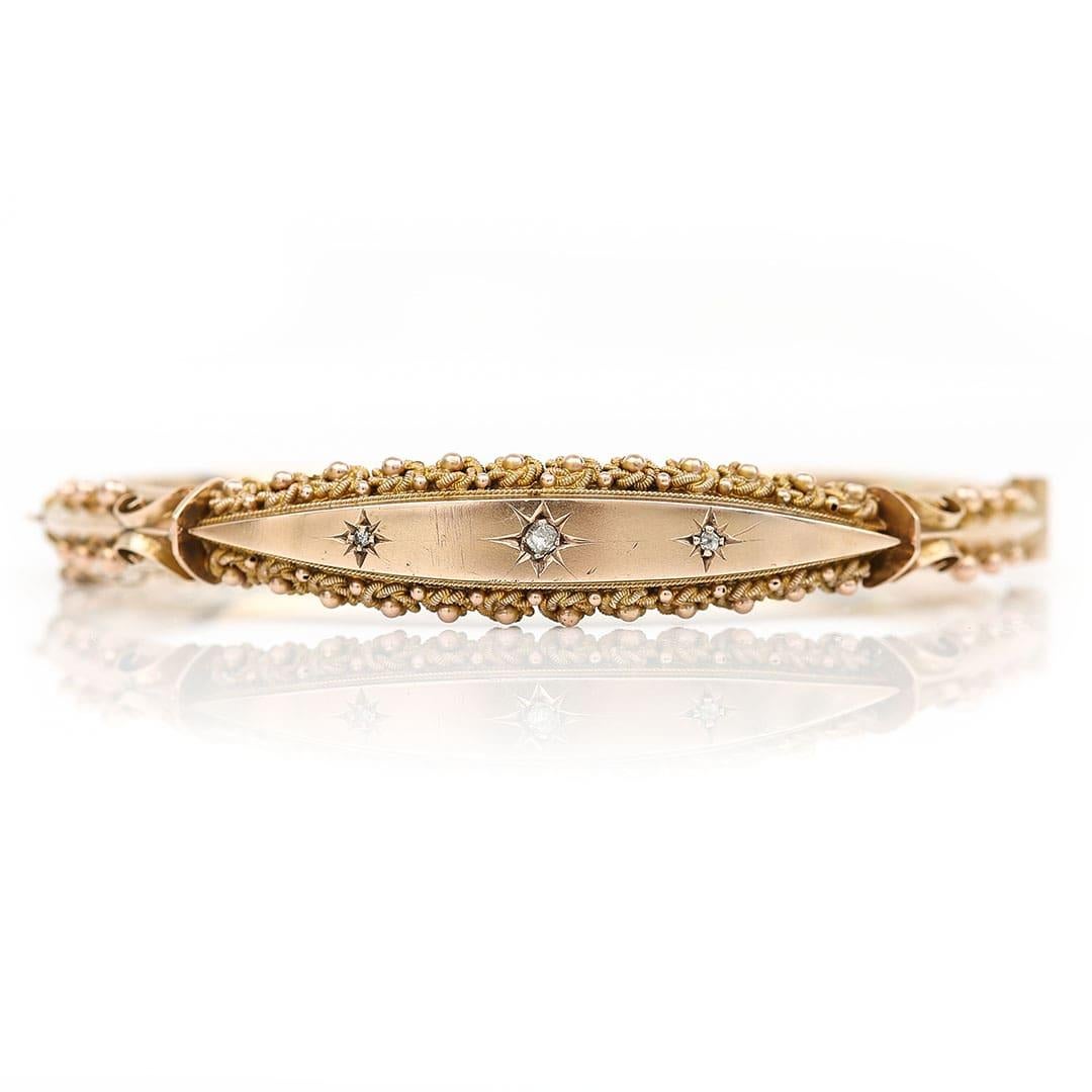 A fabulous antique Victorian 9ct yellow gold hinged bangle set with three rose cut diamonds to its head, hand crafted in 1890. The pretty bangle has beautifully ornate rope and bead decoration around the border of the head of the bangle which is so