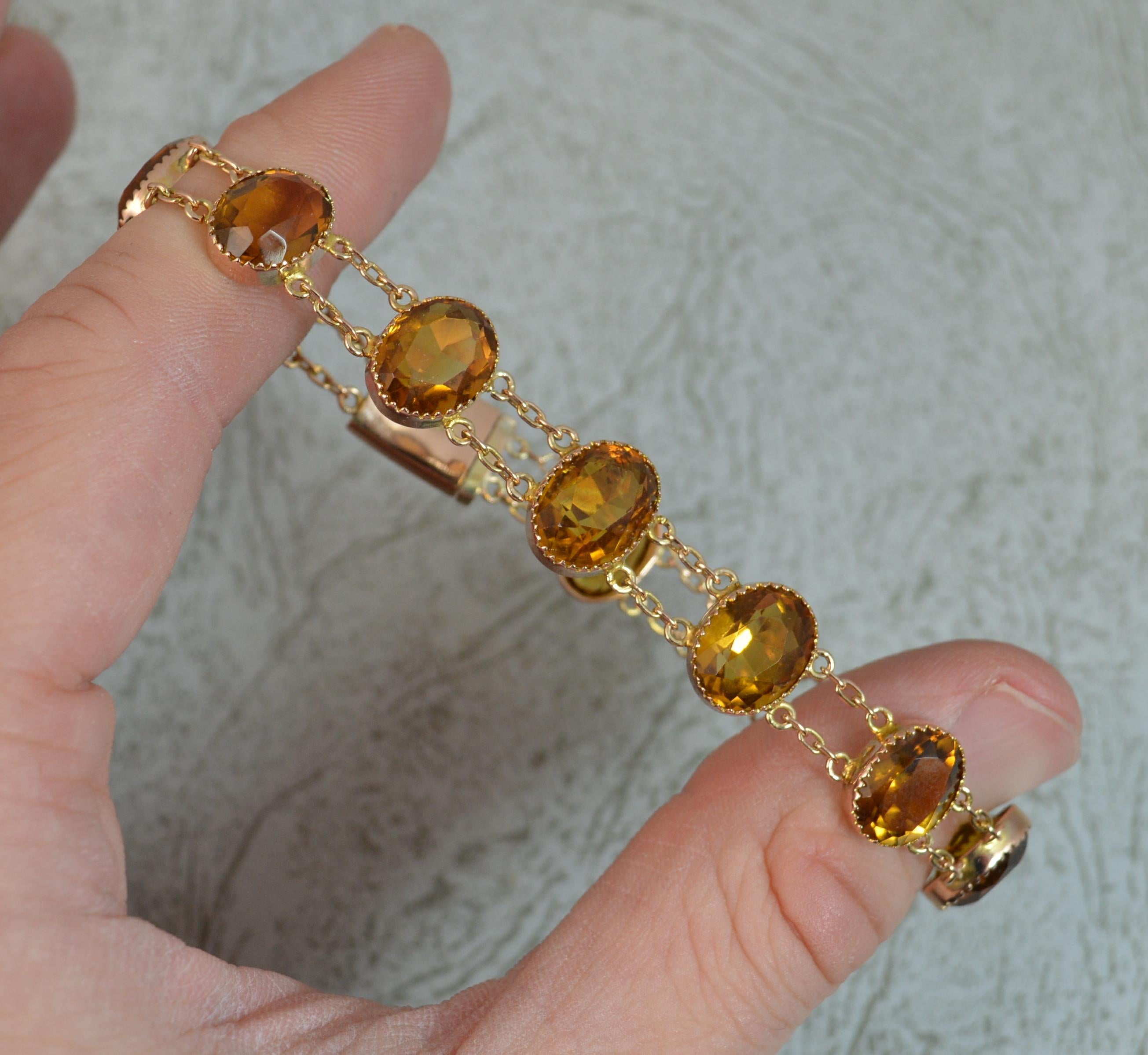 A superb mid Victorian period example. c1890.
Designed with eleven natural oval cut orange citrine stones with fine grain settings. Each held by two rows of gold link chains.
Solid 9 carat rose gold example.

CONDITION ; Very good. Well set stones.