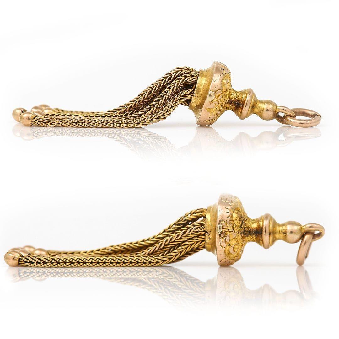 A delightful original antique, this Victorian 9ct yellow gold tassel pendant has all the charm and character expected of a period accessory. The tassel retains all its original drops and the chased detailing, despite being worn retains most of its